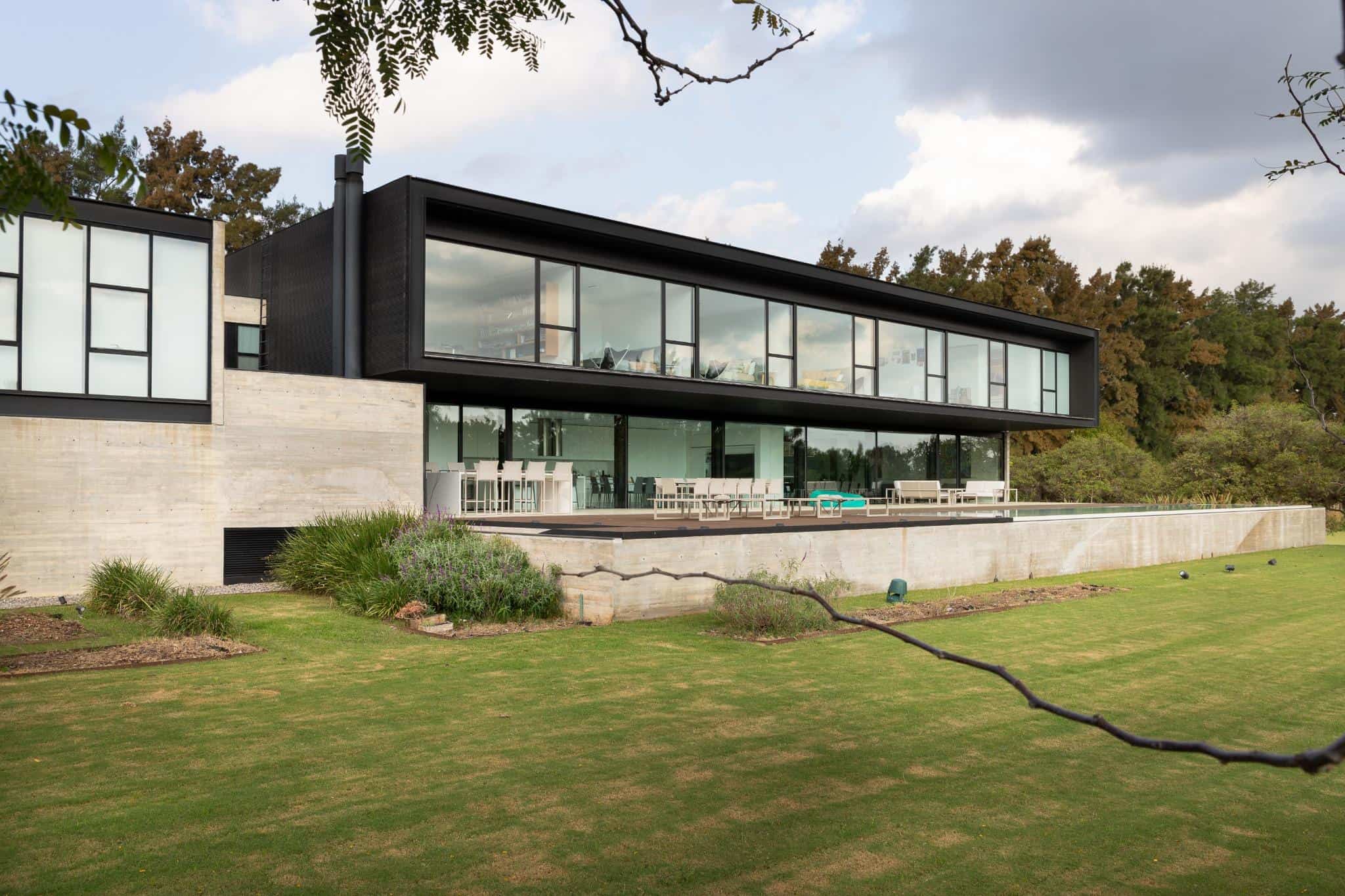Pacheco House Rear Elevation Glass Facade Back elevation of Pacheco House showcasing its long glazed volume and open terrace.