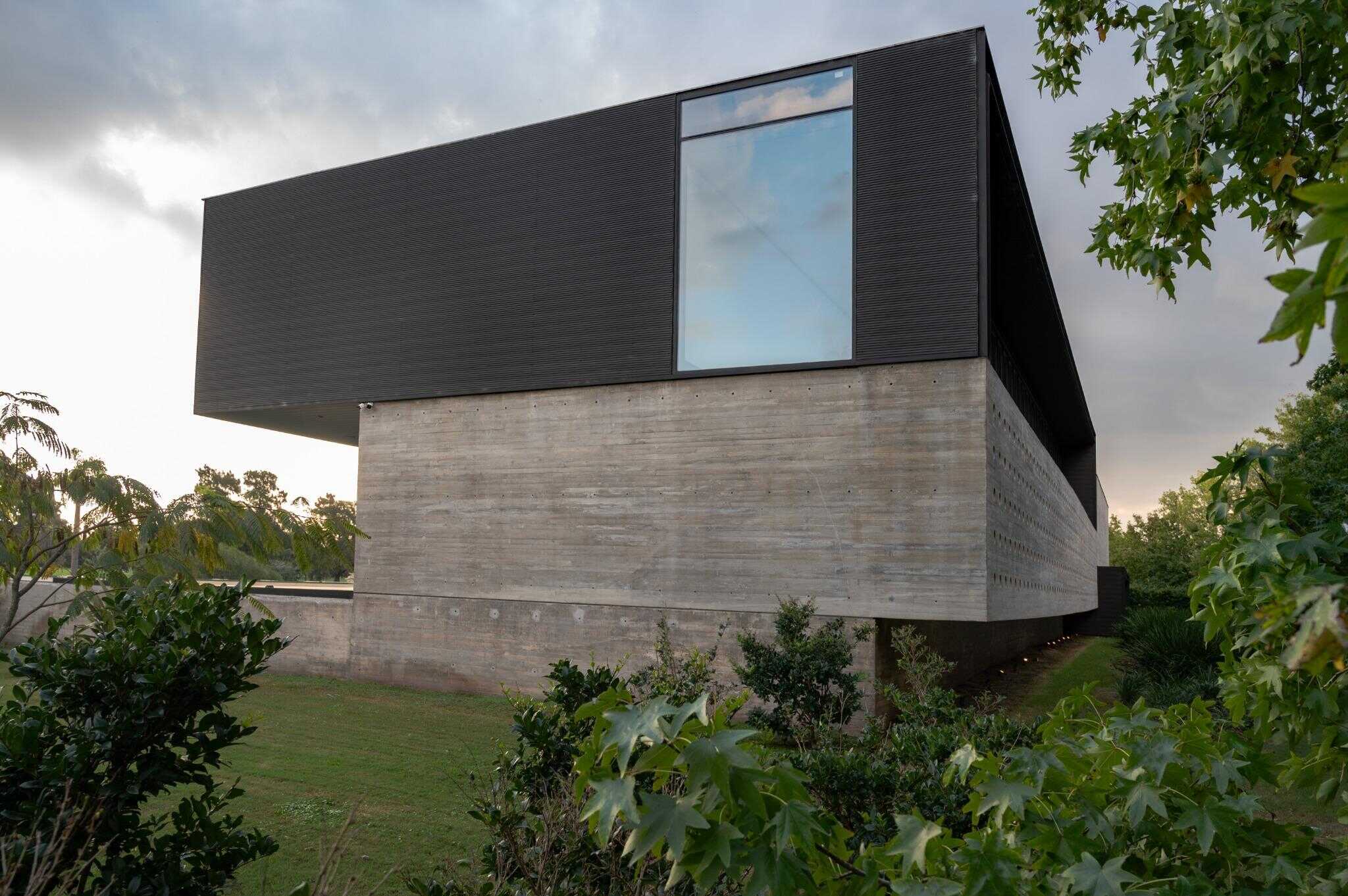 Pacheco House Side Corner Window Glass Pacheco House by A4estudio with large corner window offering expansive exterior reflections.