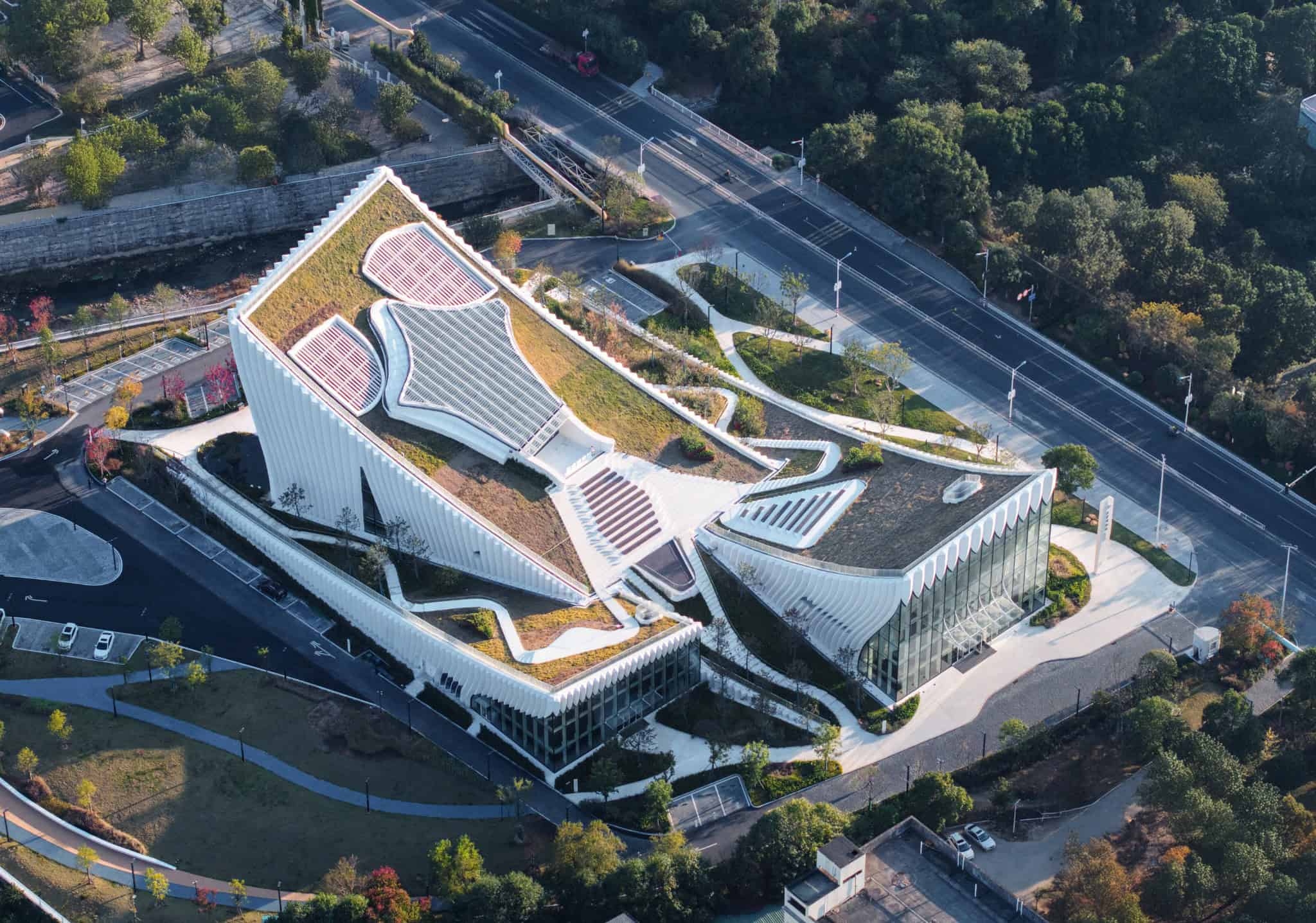 Sustainable modern architecture with green roofs and innovative design, blending eco-friendly elements and contemporary structure in an urban landscape.