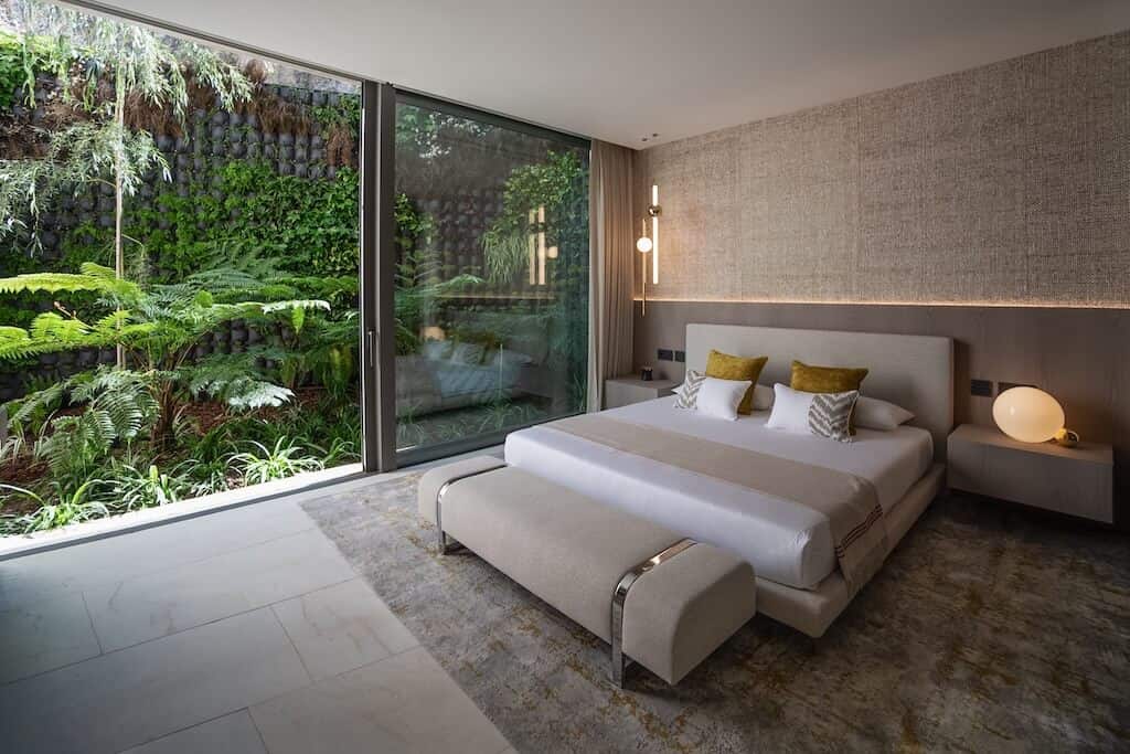 Villa Kaizen Bedroom Garden Wall Tranquil bedroom with vertical garden wall and natural textures in Villa Kaizen.
