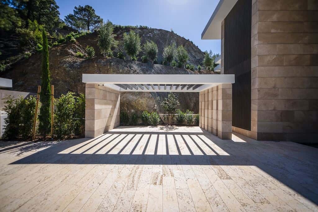 Villa Kaizen Covered Terrace Pergola-style terrace casting shadows on natural stone in Villa Kaizen.