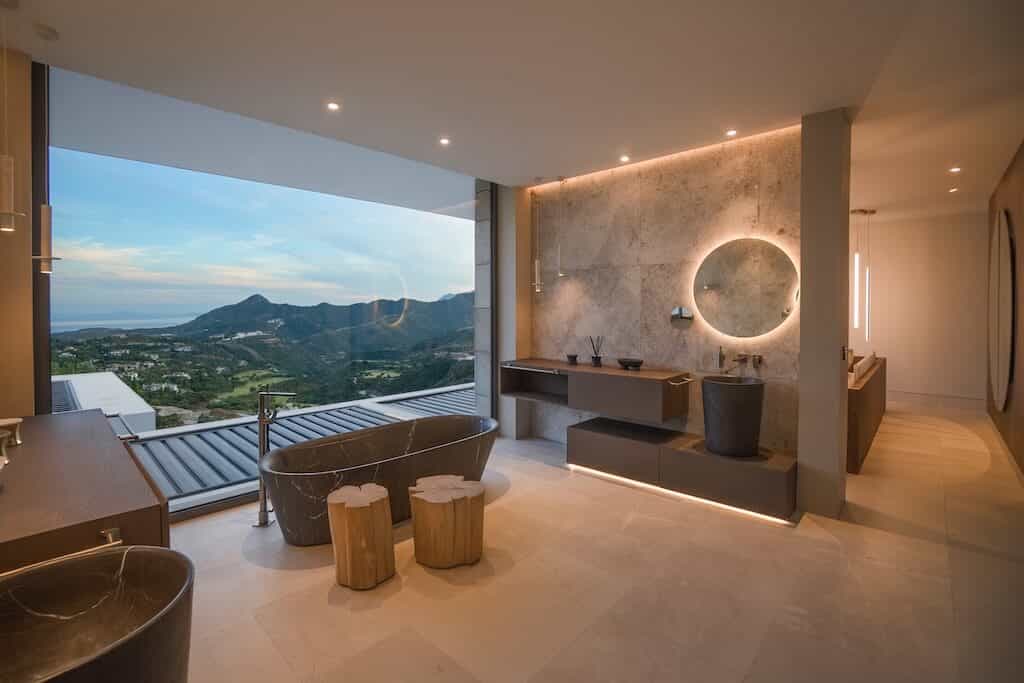 Villa Kaizen Evening Bathroom View Modern bathroom with backlit mirrors and twilight views in Villa Kaizen.