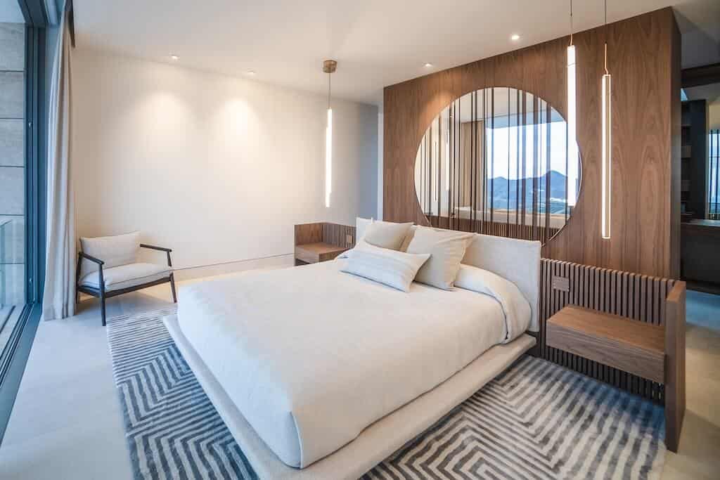 Villa Kaizen Evening Bedroom Interior Modern bedroom interior at Villa Kaizen featuring wooden accent wall and ambient lighting.