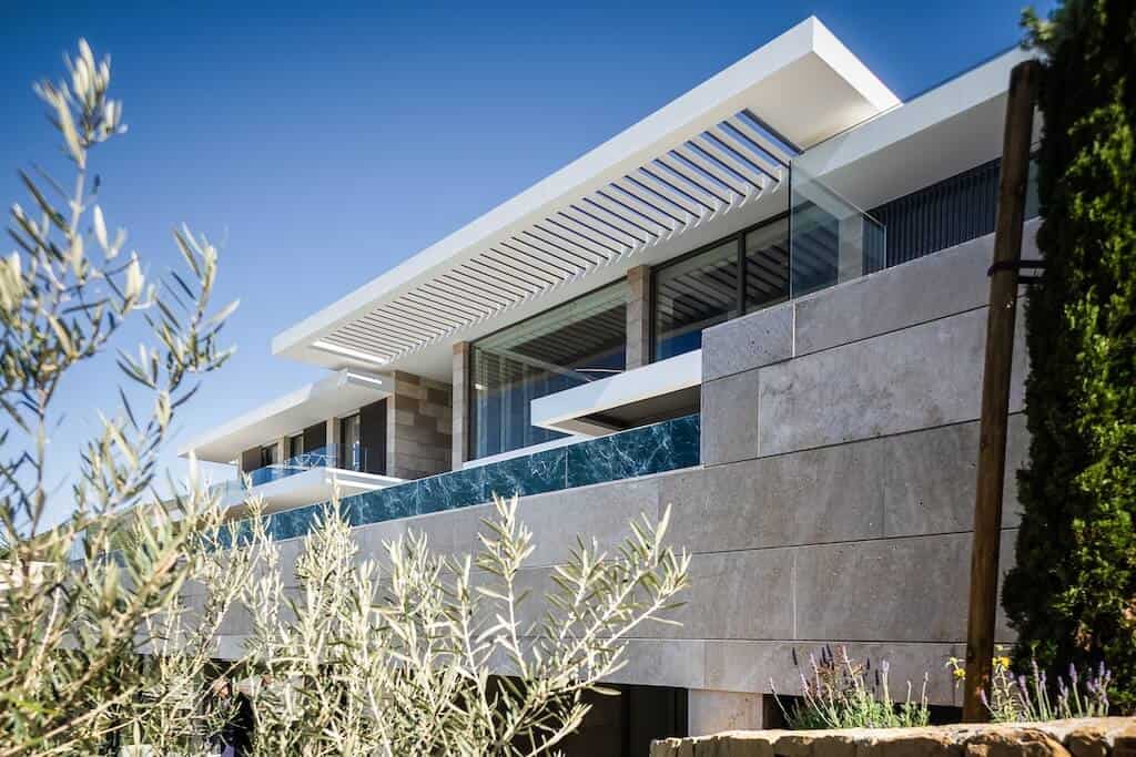 Villa Kaizen Exterior Glass Detail Close-up of architectural glass and stone facade at Villa Kaizen.