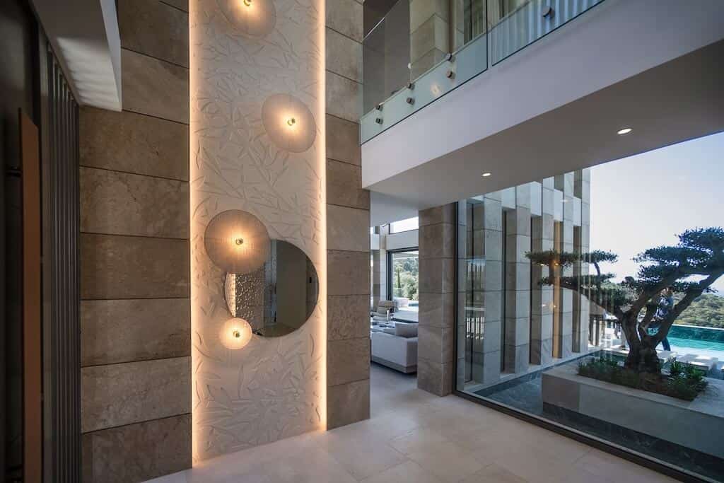 Villa Kaizen Hallway Lighting Detail Hallway detail with artistic lighting and textured walls in Villa Kaizen.