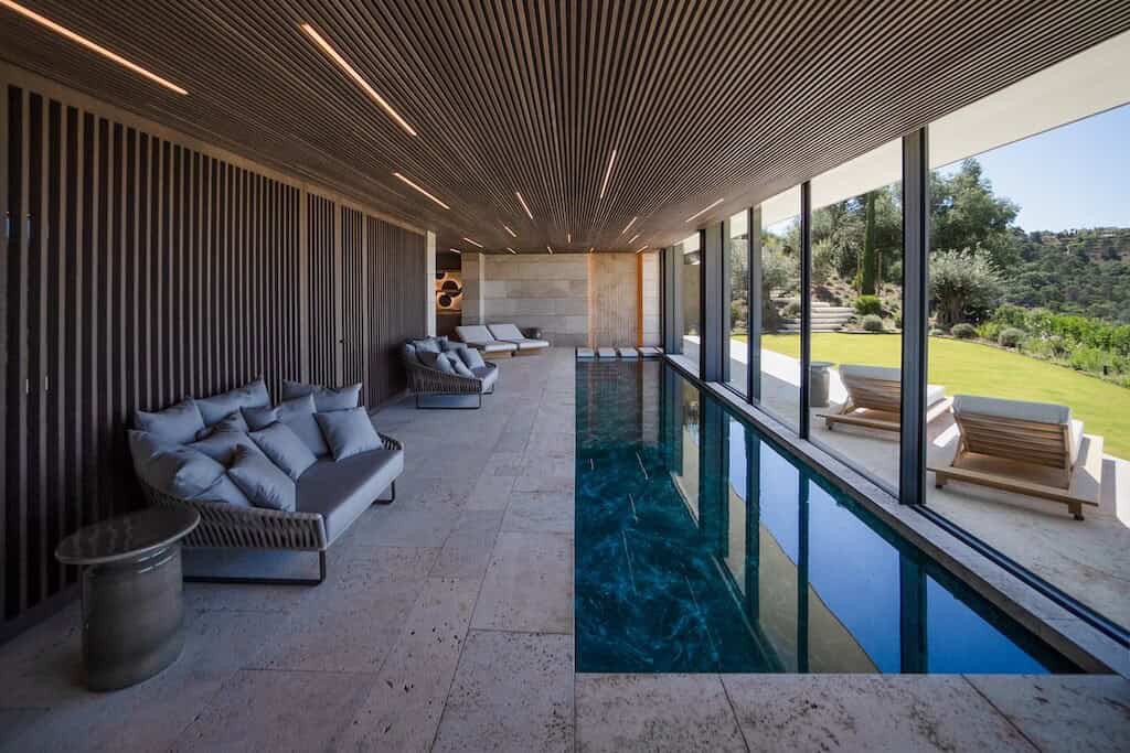 Villa Kaizen Indoor Pool Loungers Indoor pool at Villa Kaizen with lounge seating and view of the garden.