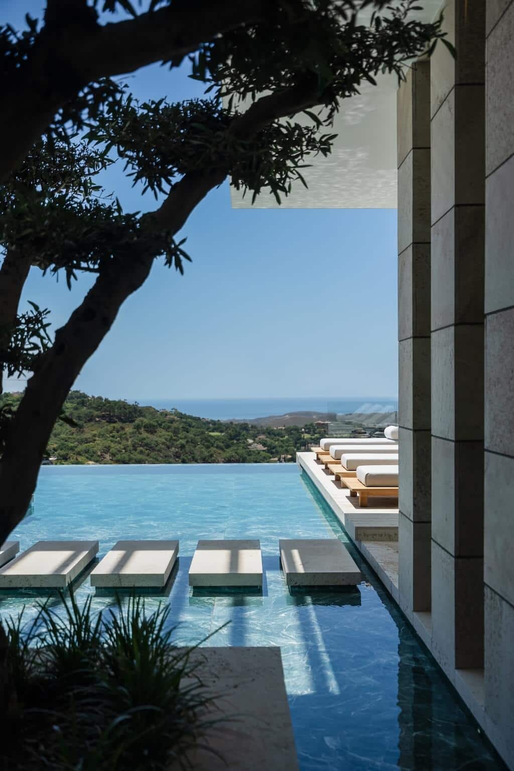 Villa Kaizen Infinity Pool Sea View Infinity pool with sunken loungers and distant sea view from Villa Kaizen.