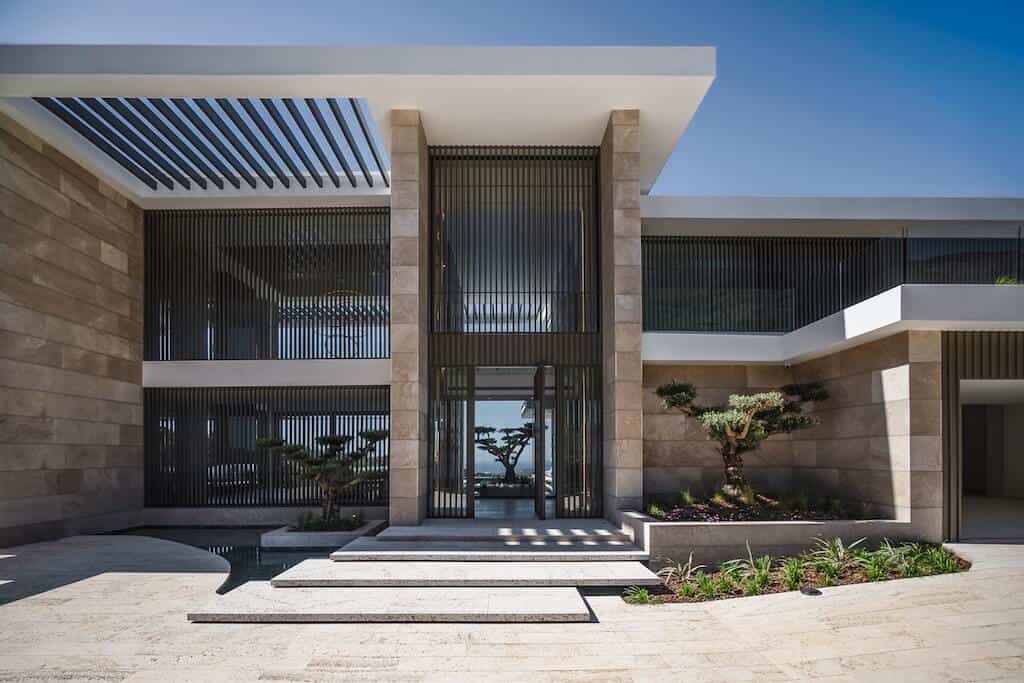 Villa Kaizen Main Entrance Grand entrance of Villa Kaizen with sculptural landscaping and vertical louvers.