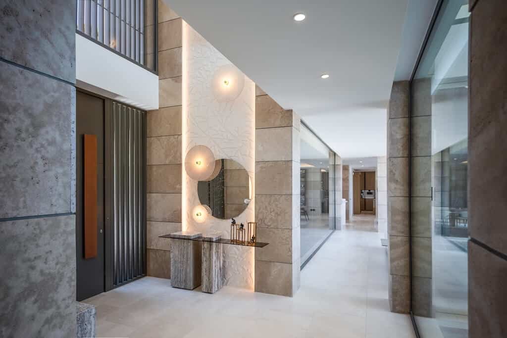 Villa Kaizen Modern Entry Hall Elegant entry hall at Villa Kaizen with backlit sculptural wall and marble console.