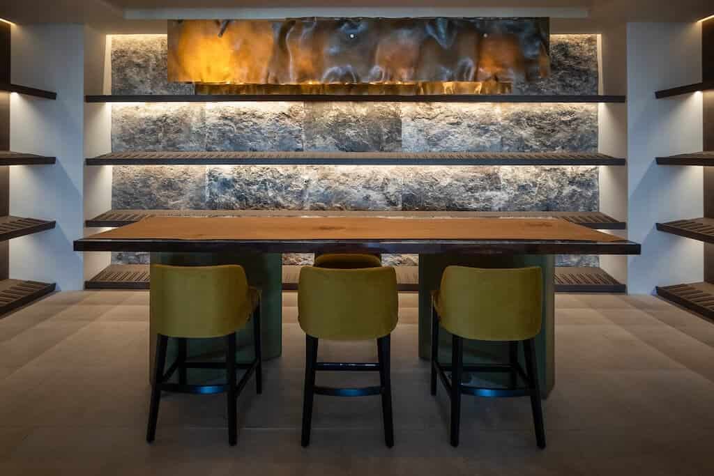 Villa Kaizen Modern Wine Cellar Sleek wine cellar with stone backdrop and accent lighting in Villa Kaizen.