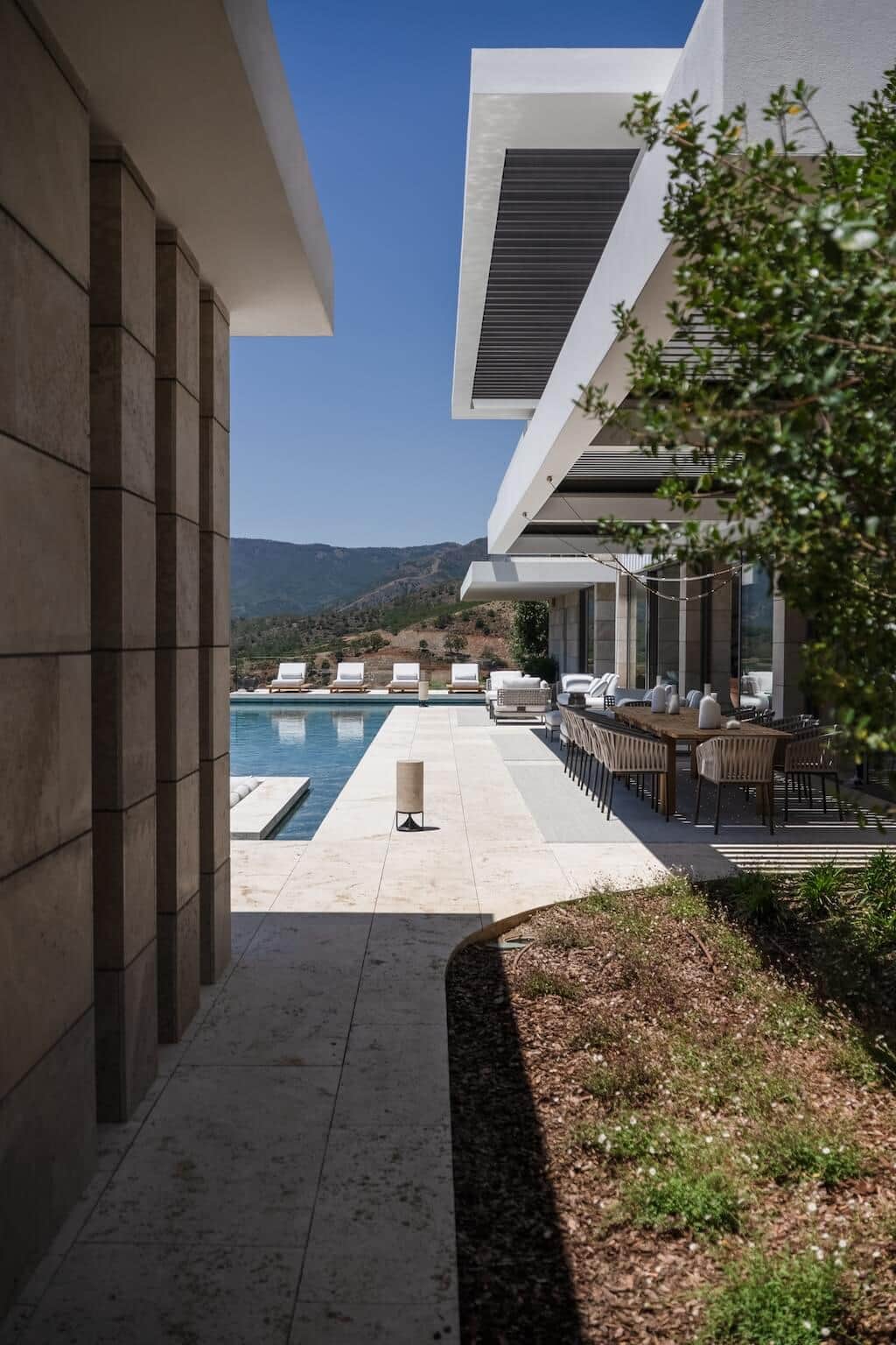 Villa Kaizen Poolside Dining Terrace View of the poolside dining terrace at Villa Kaizen framed by modern architecture.