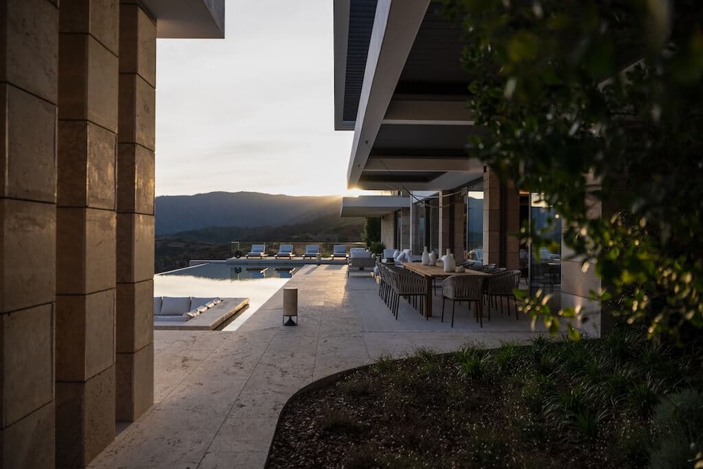 Villa Kaizen Sunset Poolside Dining Poolside dining and lounging area at sunset at Villa Kaizen with serene mountain backdrop.