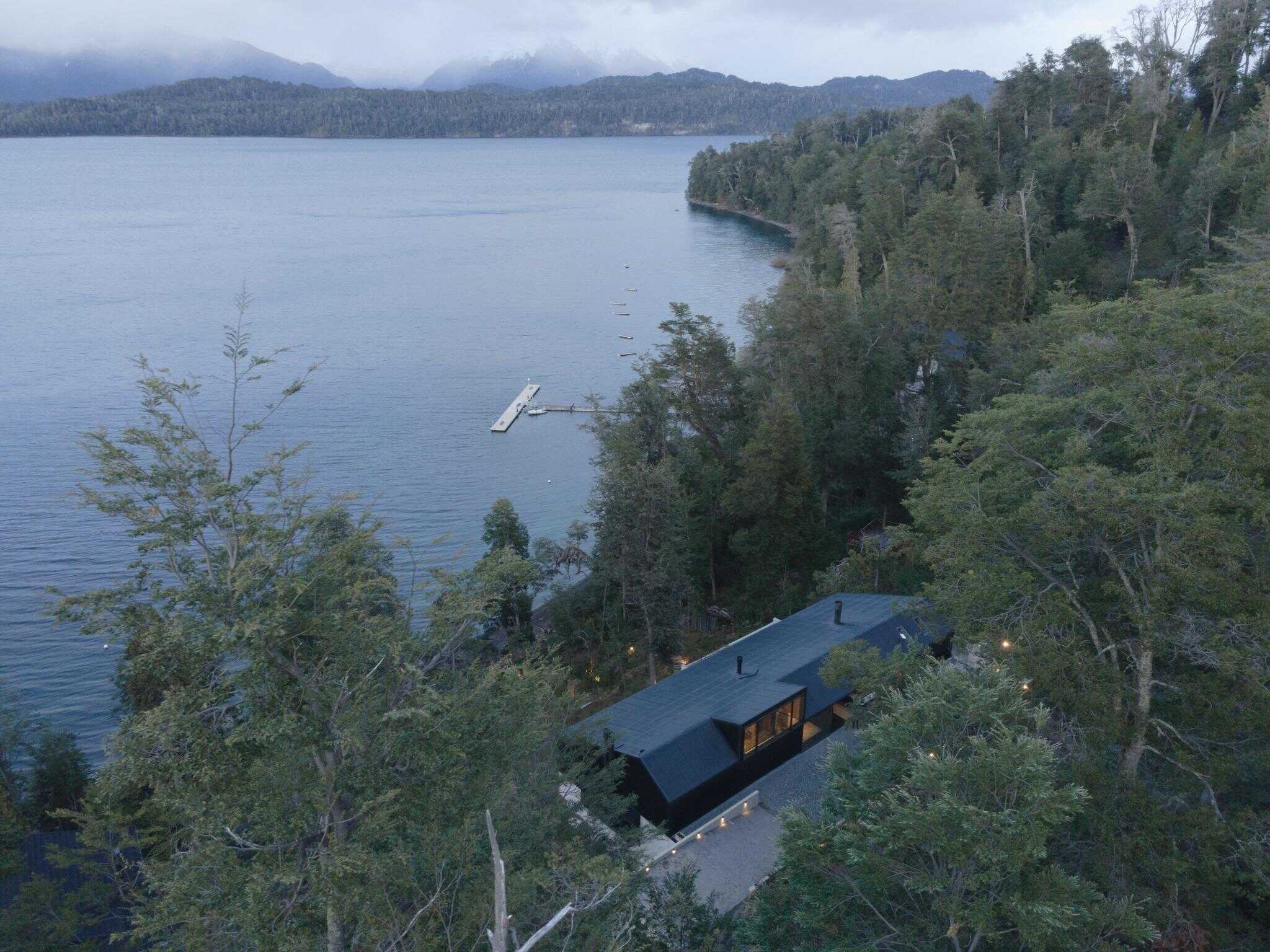 Aerial view of VLA House by A4estudio situated by the lake.