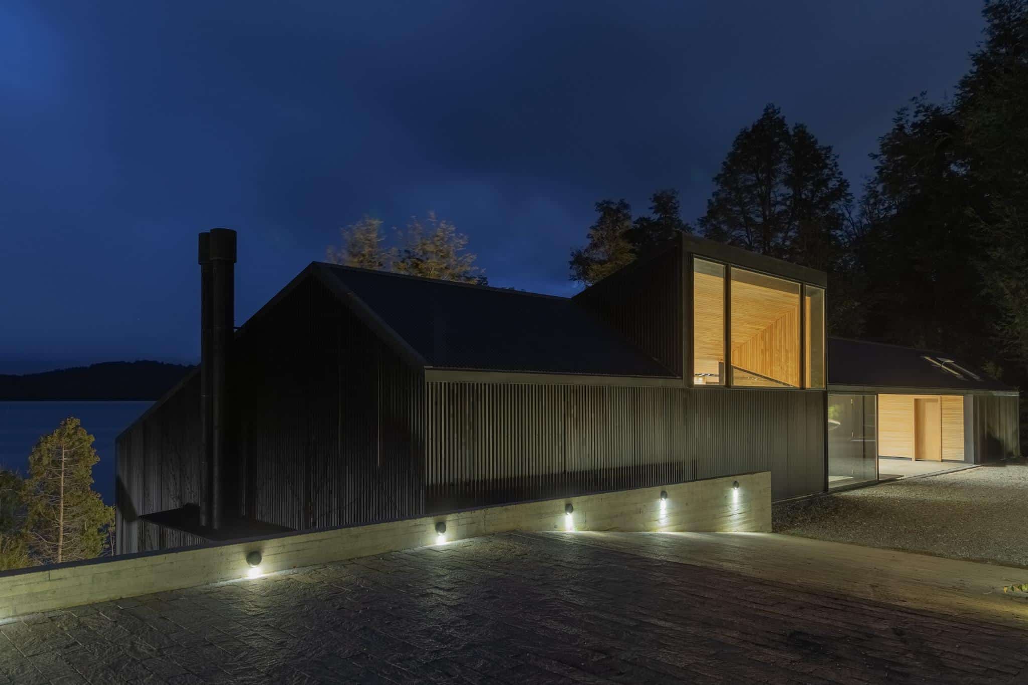 Night view of black cabin entrance at VLA House by A4estudio.