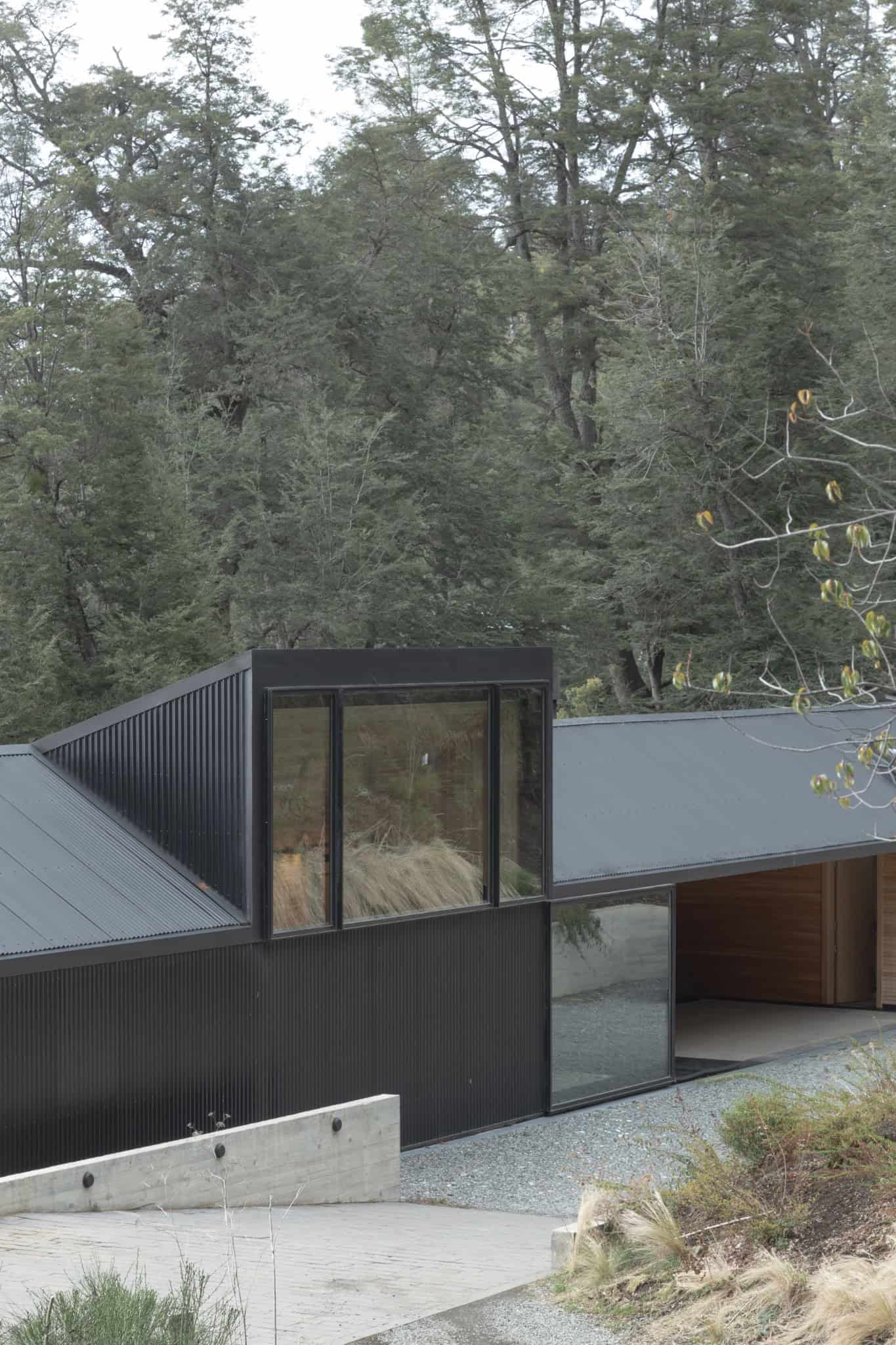 Detailed view of black metal and glass volume of VLA House by A4estudio.