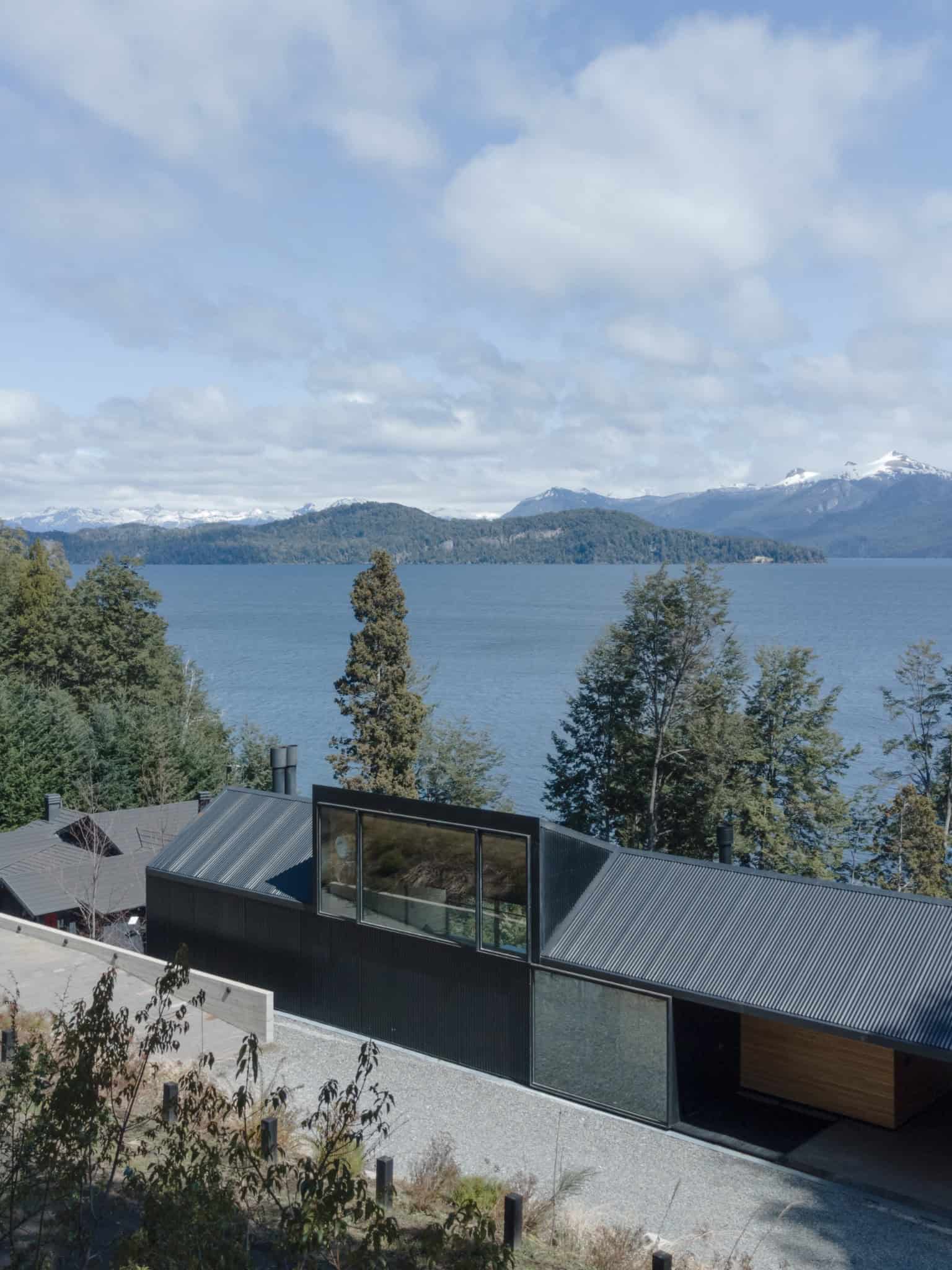Black corrugated metal facade of VLA House with minimalist lines.