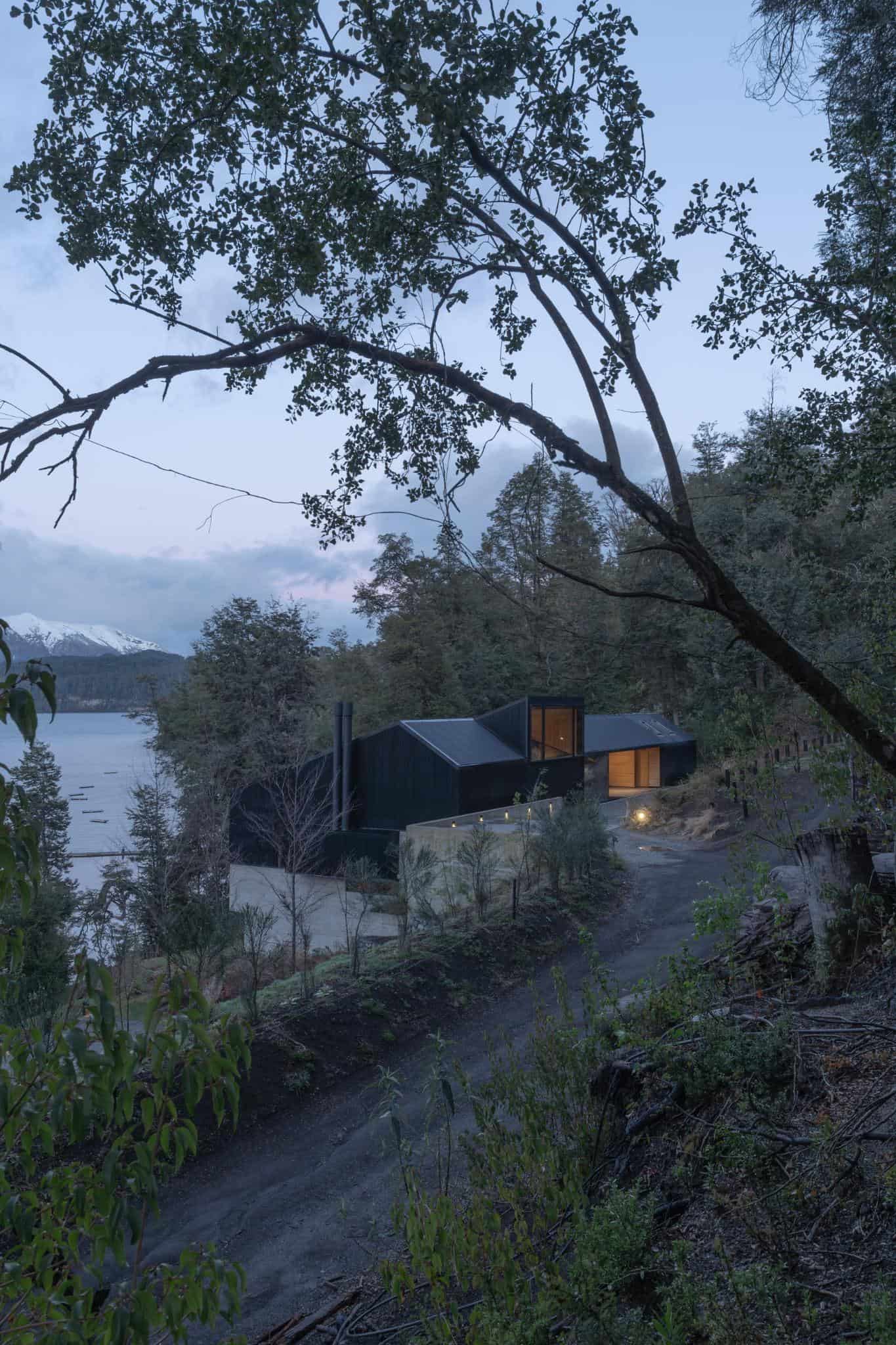 VLA House by A4estudio viewed from hillside surrounded by forest.