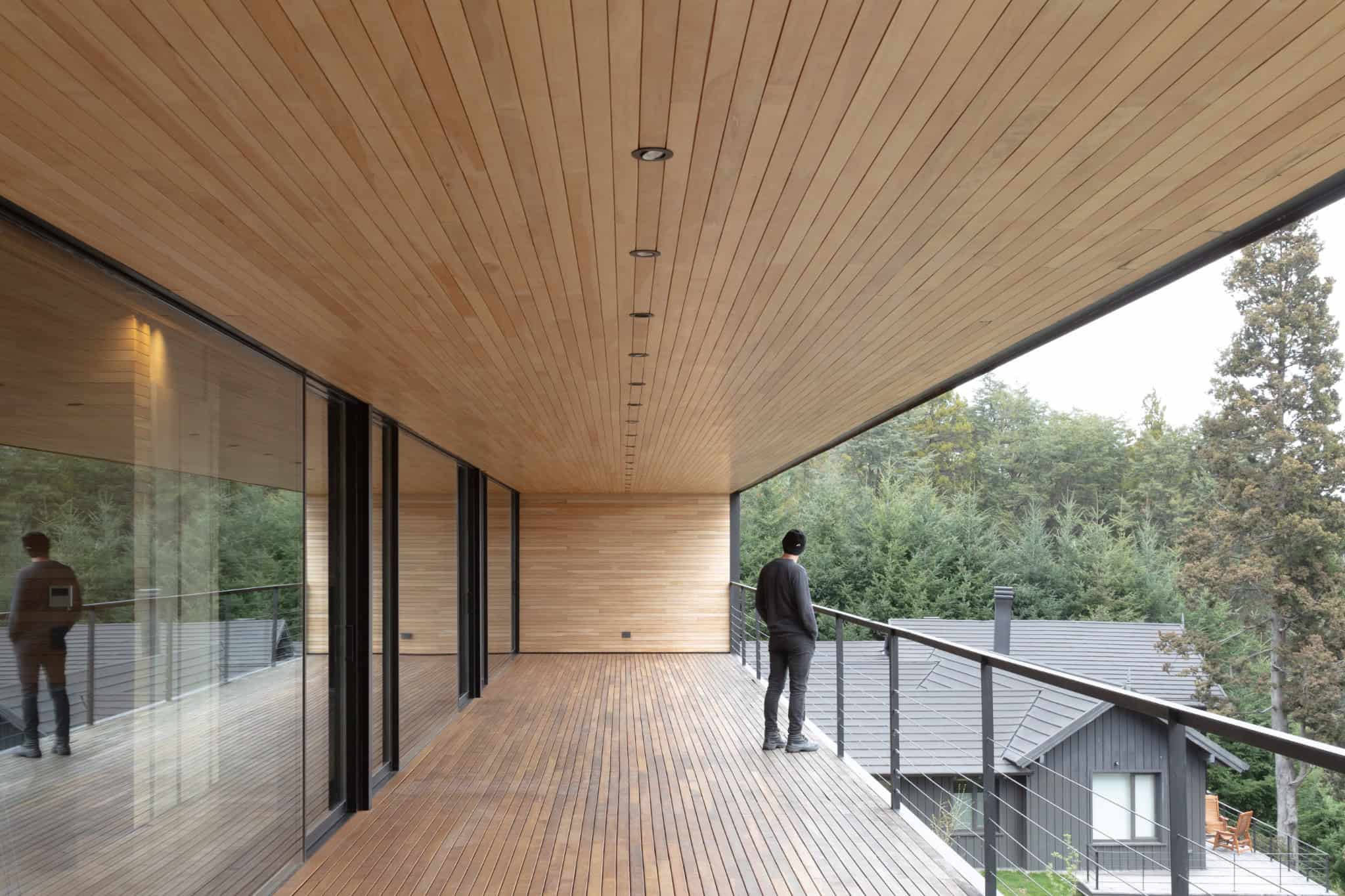 Long covered balcony with timber ceiling reflecting landscape at VLA House.