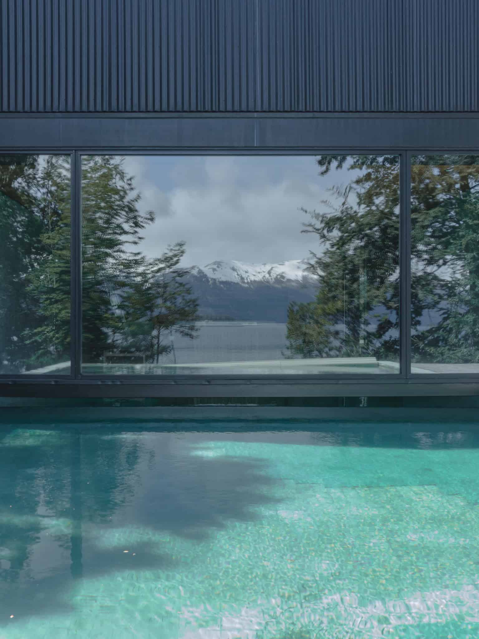 Reflections of Andes in the glass façade of VLA House.