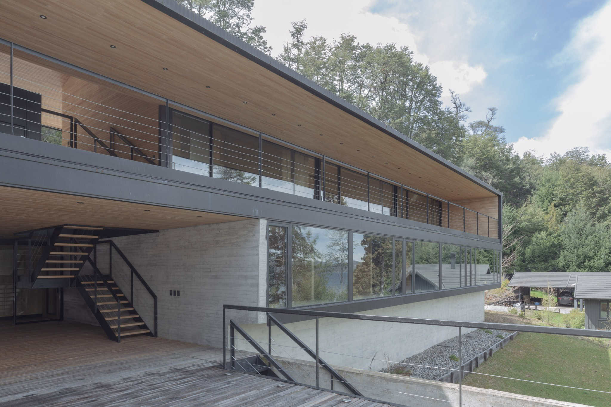 Modern staircase connecting upper deck at VLA House by A4estudio.