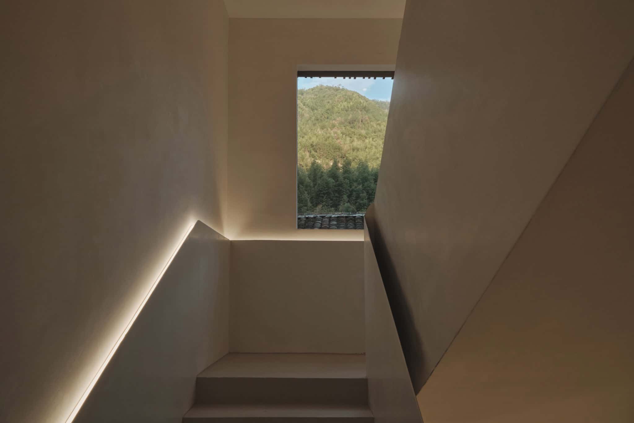 Ascending Steps into Nature - Z Museum Staircase leading up to a window with a view of lush green mountains