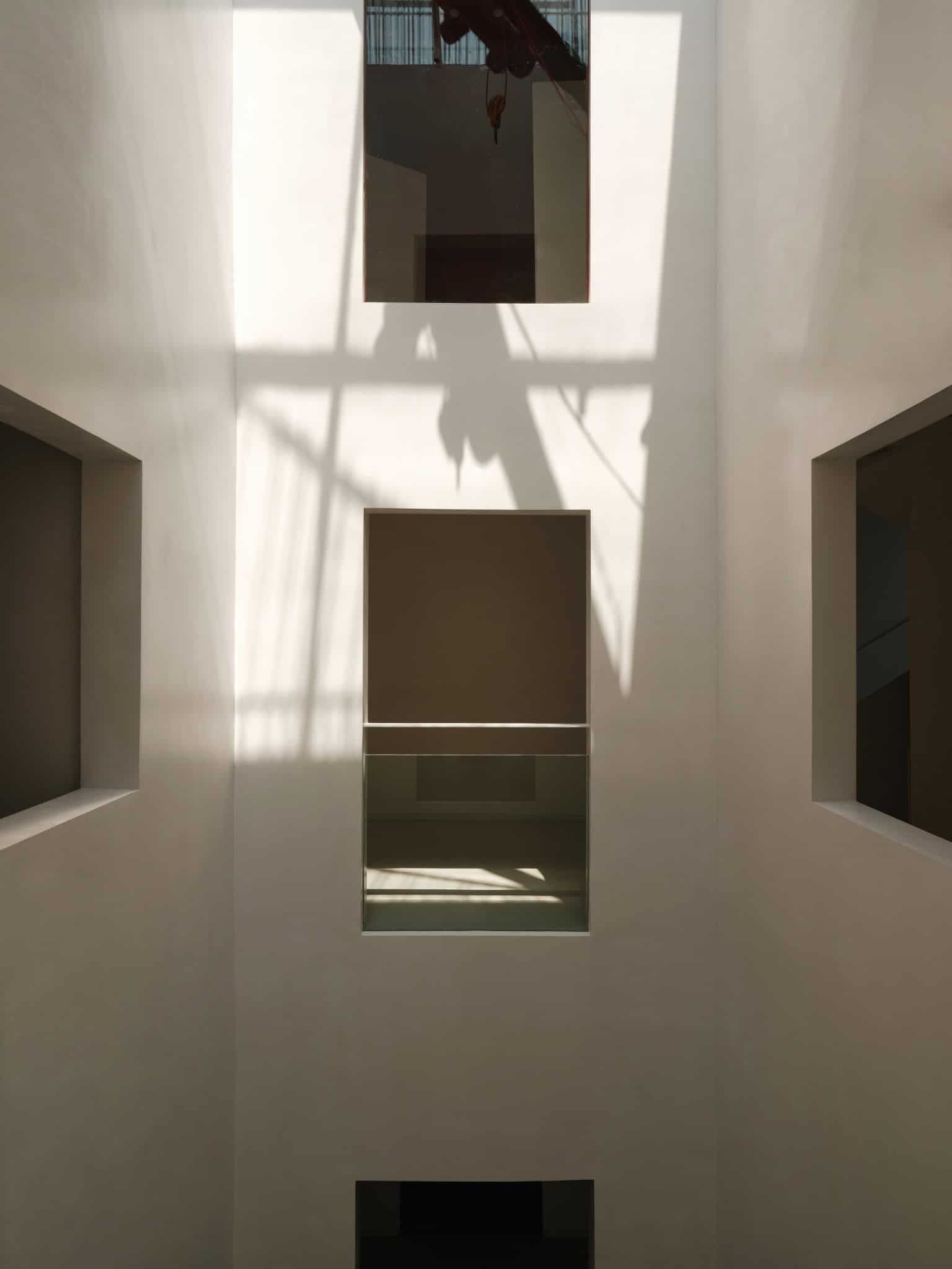 Natural Light Cascading in Atrium Shadows cast by skylights in Z Museum's white-walled atrium