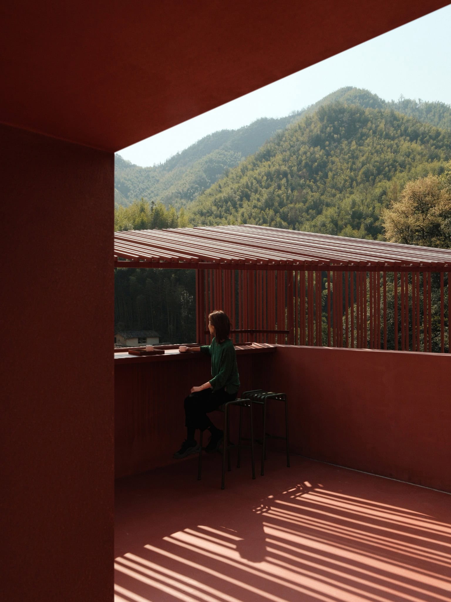 Bar Viewfinder Grille Opening - Z Museum Framed view through the red grilles at Z Museum's bar area