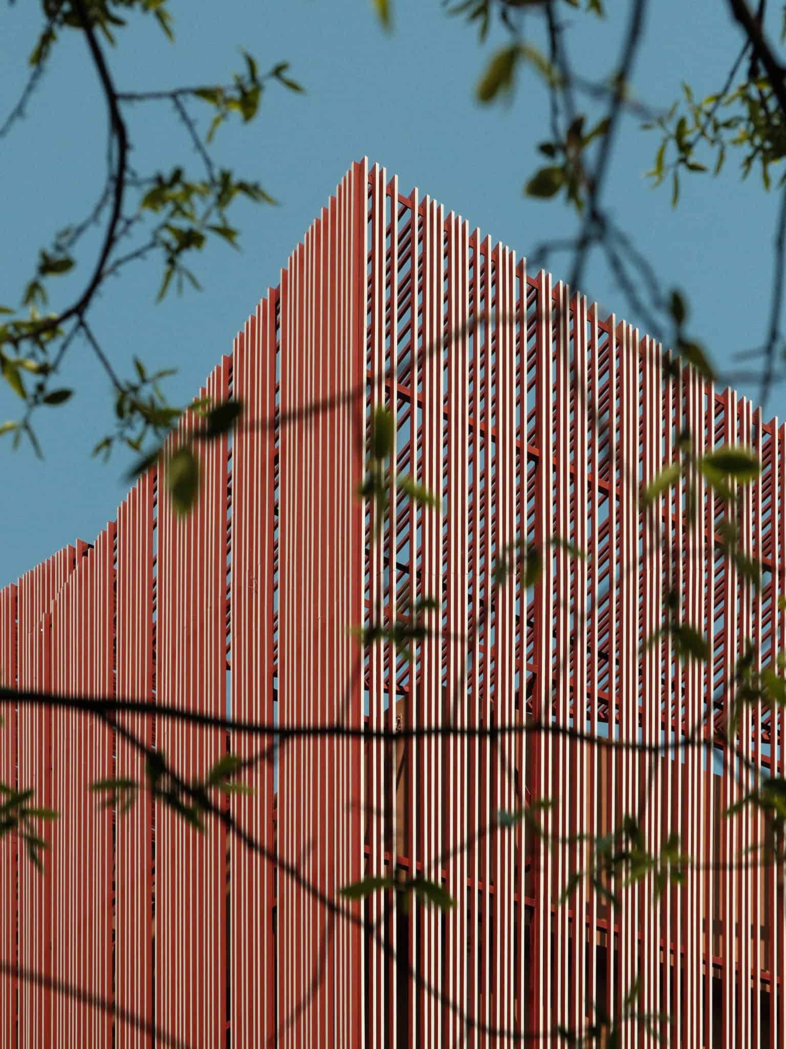 Z Museum Facade Grille White Red Close-up of Z Museum’s vertical grille with white fronts and earth red sides