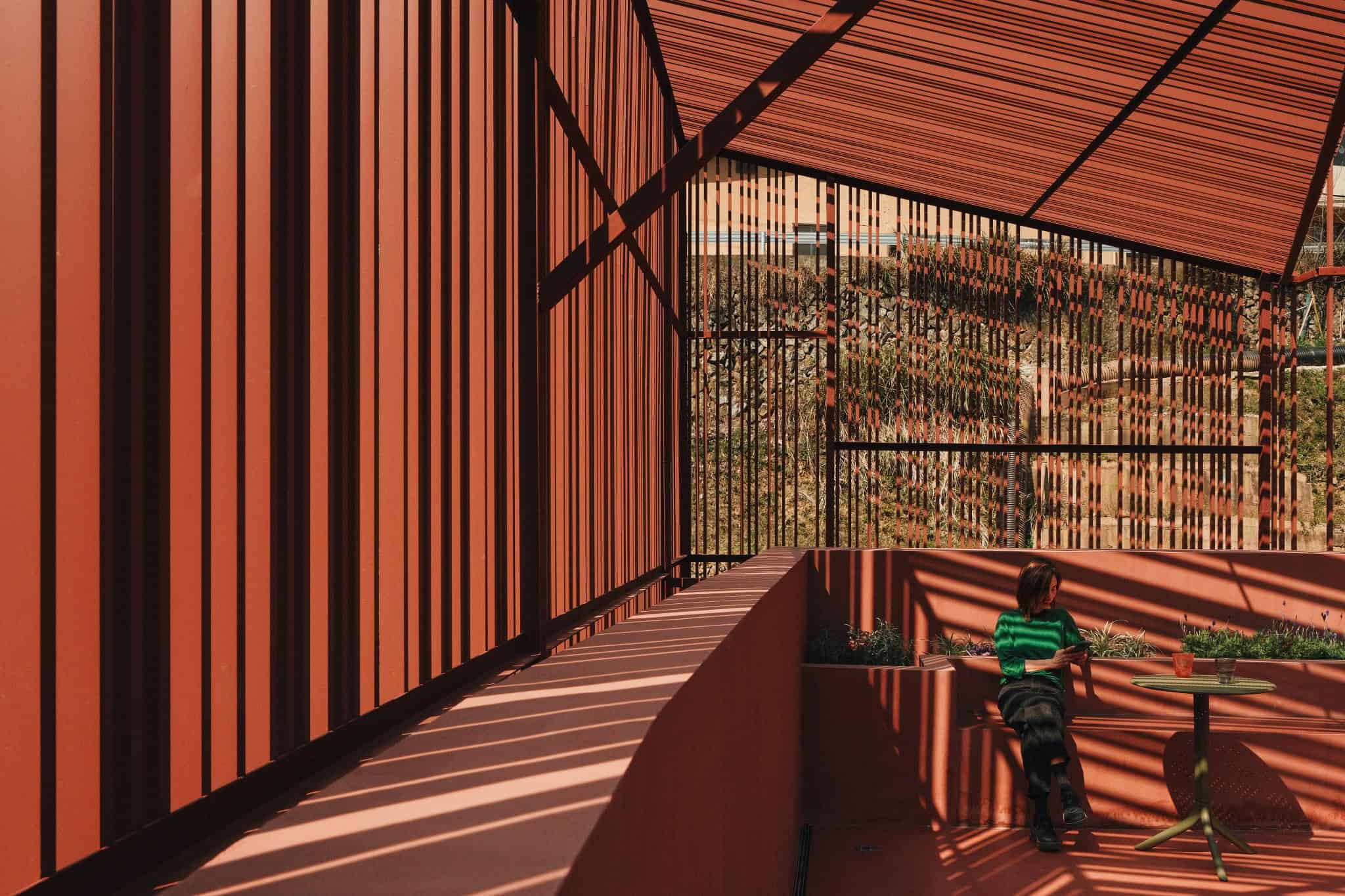 Grille Shadows on Flower Booths - Z Museum Shadows from vertical grilles cast onto seating area with flower beds