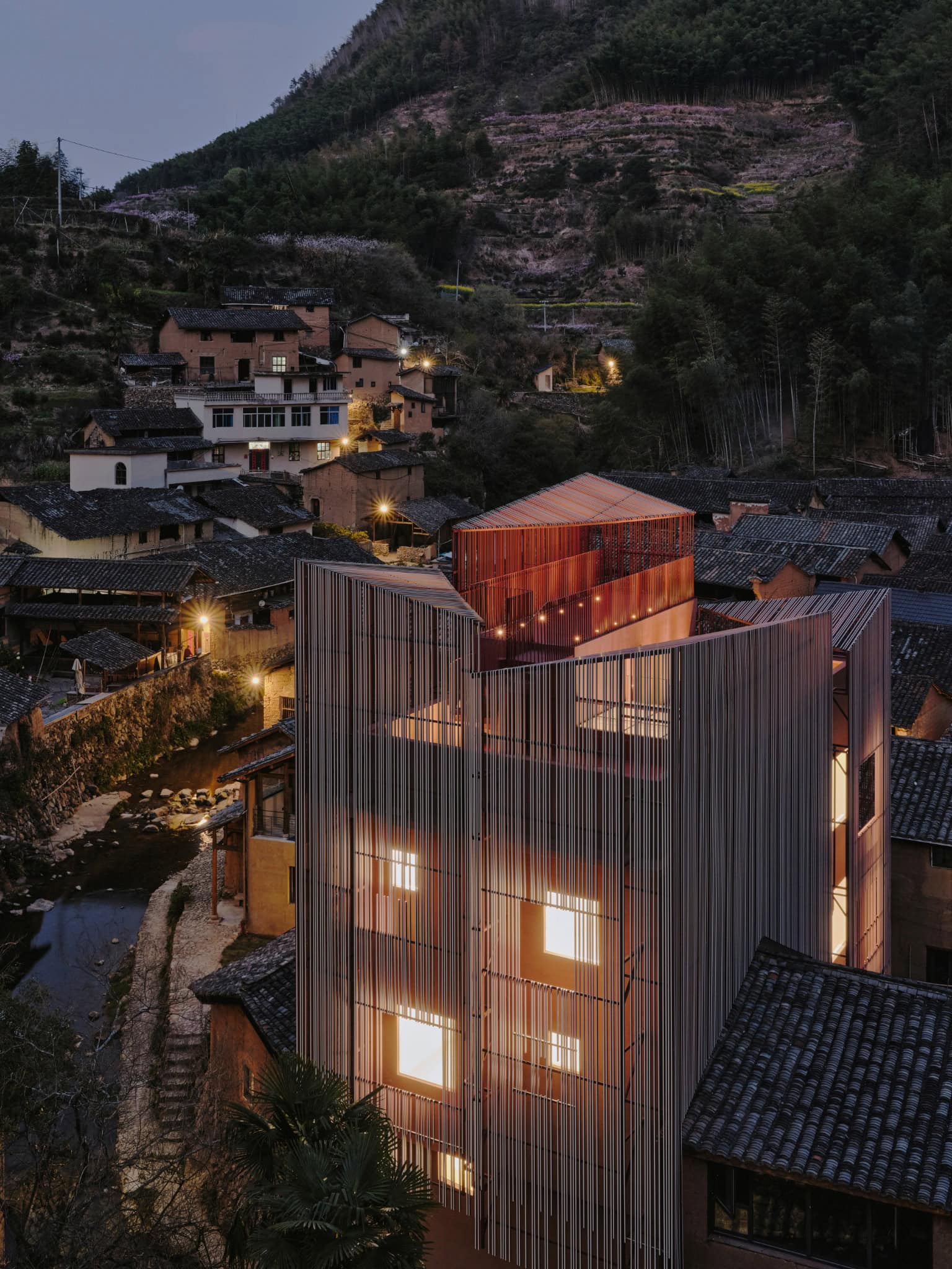 Nighttime Hazy Lighthouse - Z Museum Z Museum glowing at night like a lighthouse amidst tiled roofs