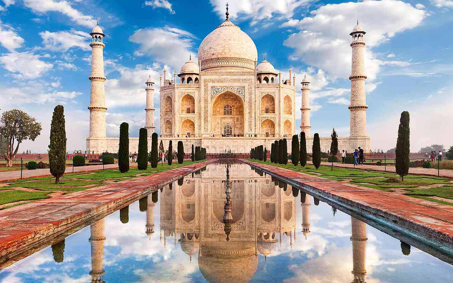 The Taj Mahal in Agra, white marble mausoleum with dome, minarets, and reflecting pool