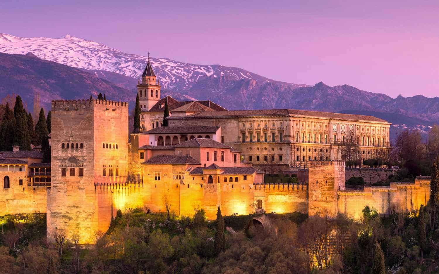 The Alhambra palace and fortress complex in Granada, Spain, glowing in evening light