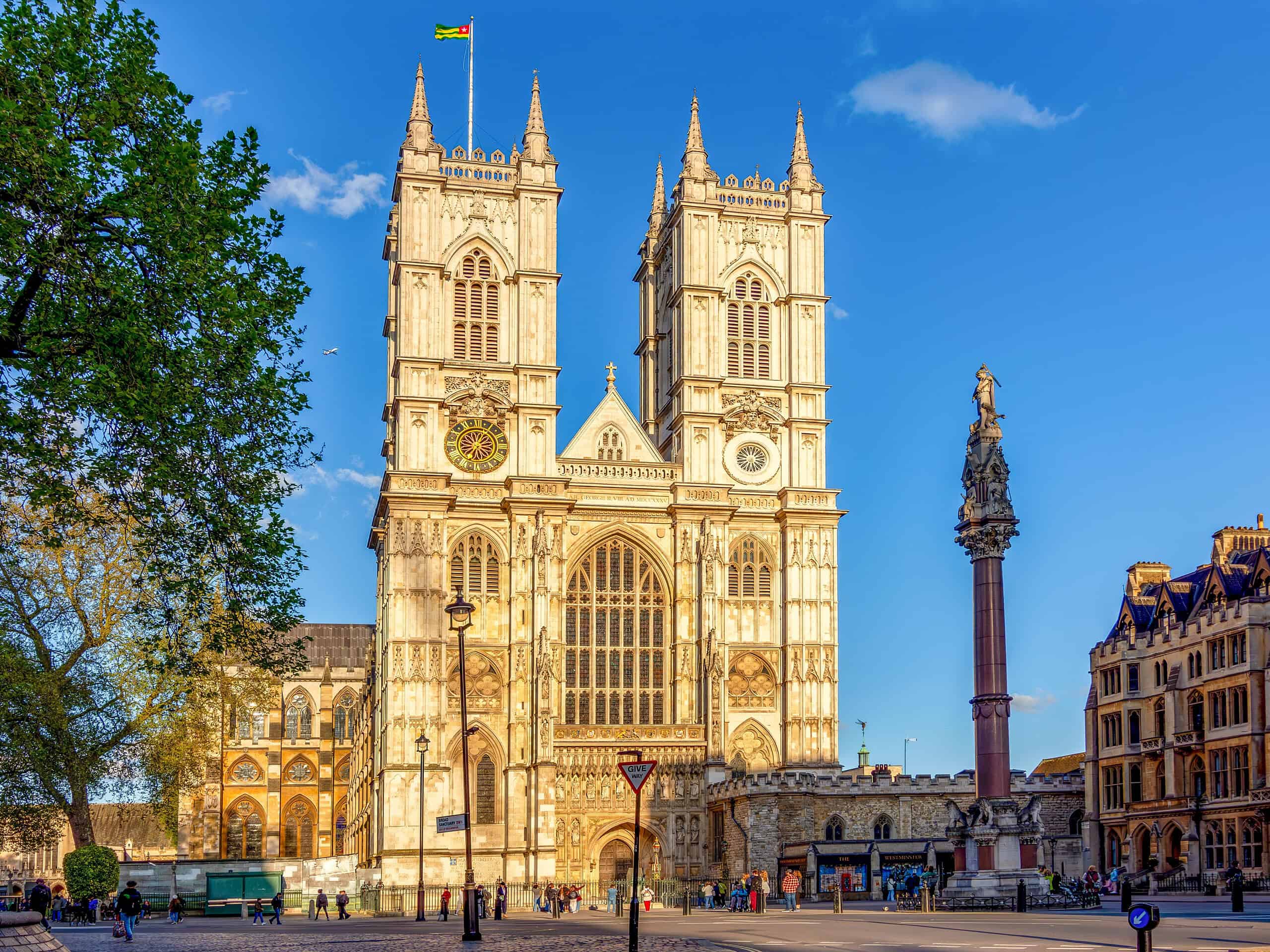 The west façade of Westminster Abbey in London, featuring gothic towers and large arched entrance