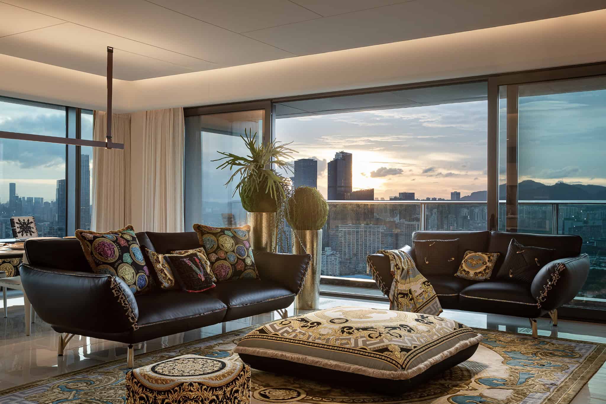 Luxurious modern interior living room with floor-to-ceiling windows, city skyline view, elegant sofas, and stylish decor, showcasing contemporary architecture and sophisticated design elements.