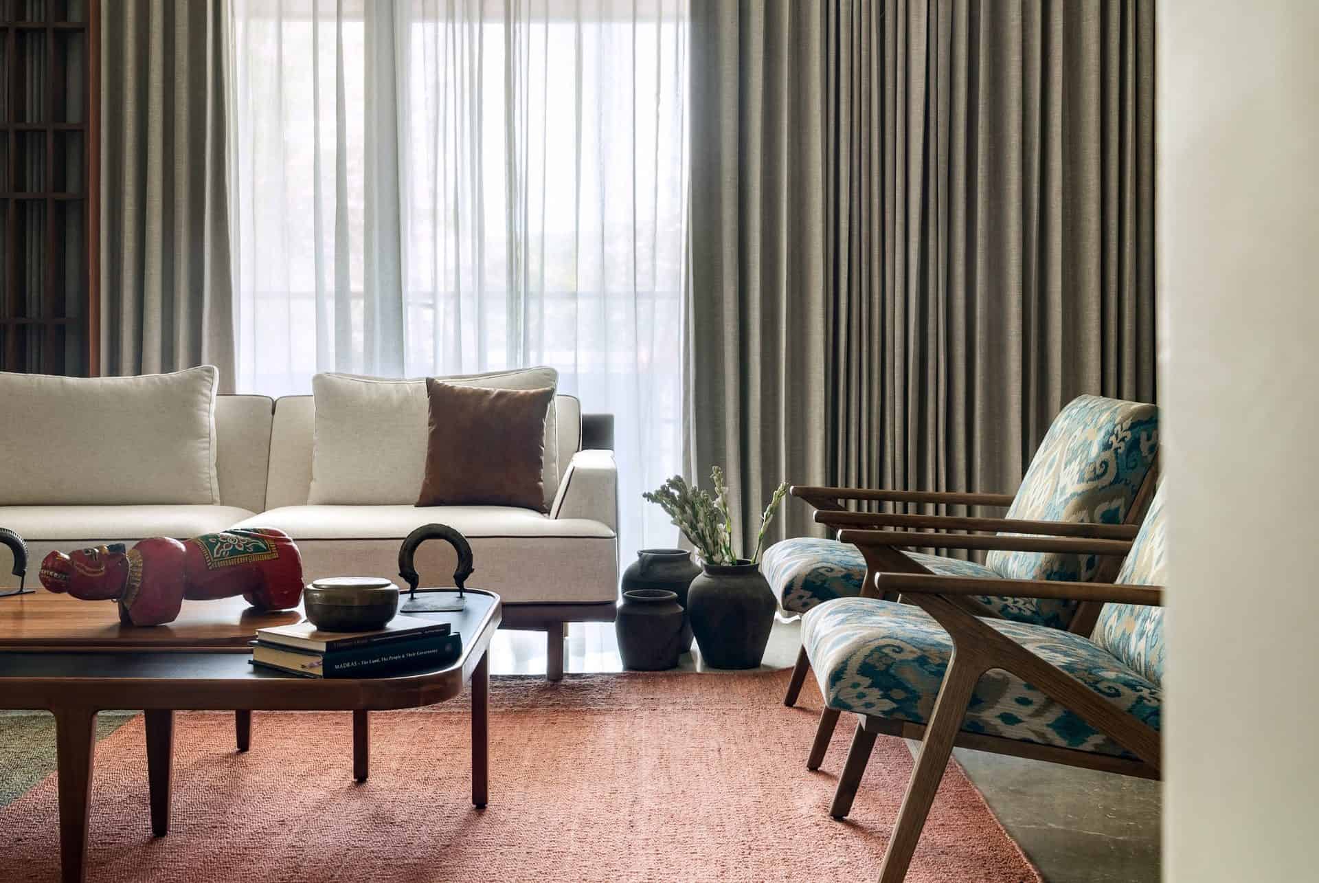 Modern living room with minimalist furniture, cozy curtains, and stylish decor, showcasing contemporary interior design elements and comfortable seating arrangements for elegant home aesthetics.