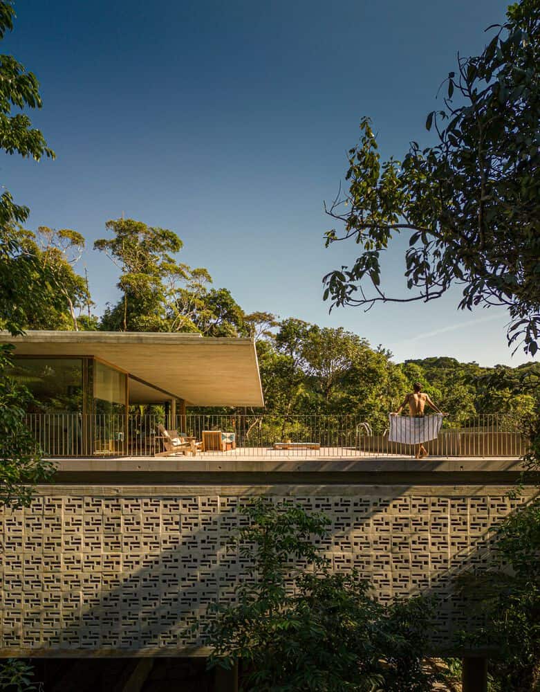 Canopy House Terrace View by Studio MK27 Terrace view of Canopy House by Studio MK27 with a man overlooking the forest, Guarujá, Brazil