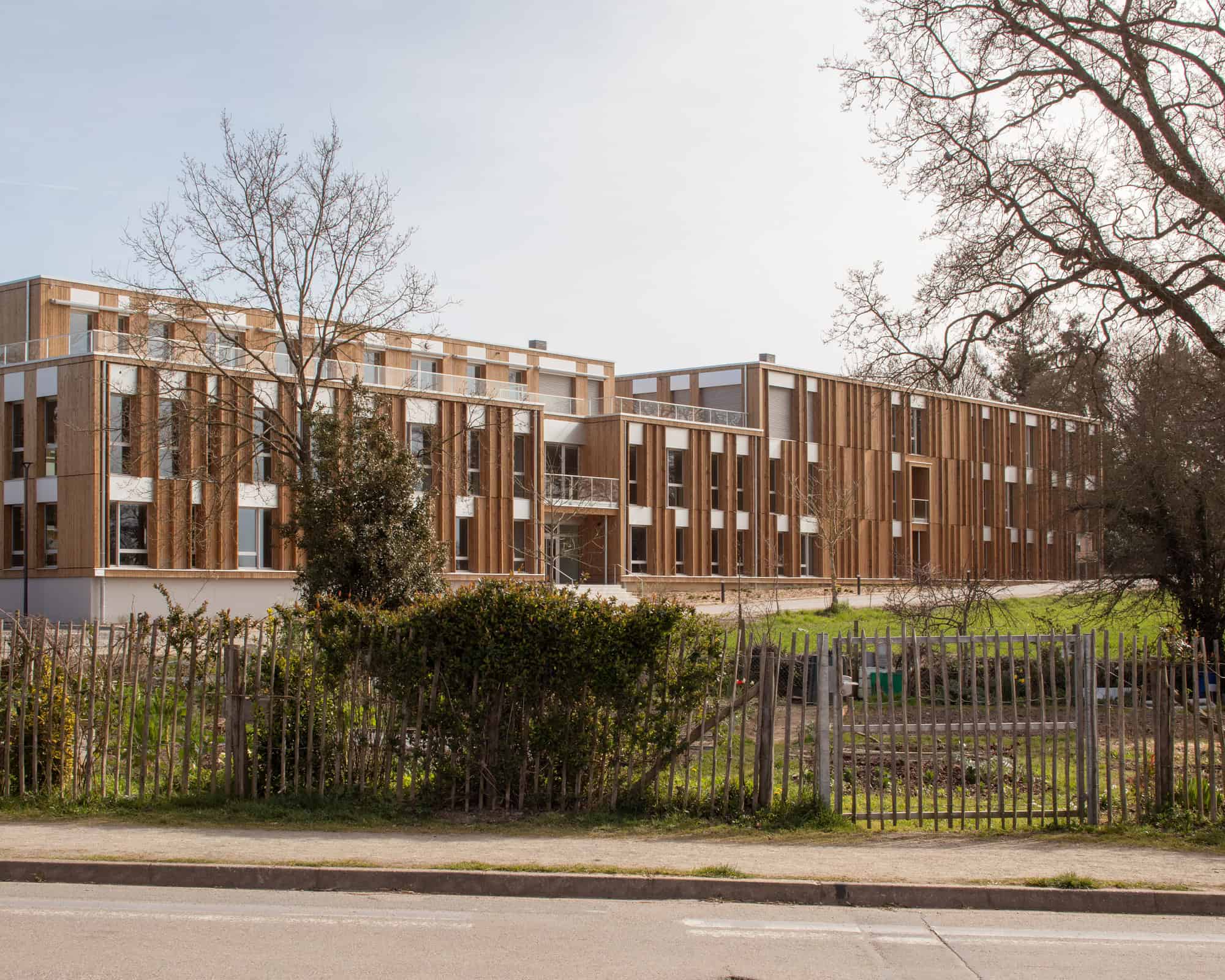 Le Chemin du Bois Harel Front Elevation Over Fence by ALTA Architectes Le Chemin du Bois Harel by ALTA Architectes — Front Elevation Over Fence, Rennes / Saint-Jacques-de-la-Lande, France