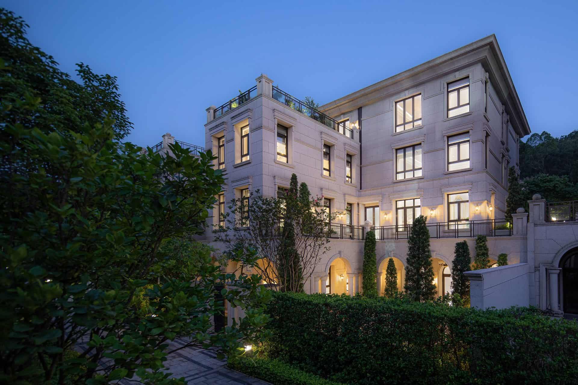 Luxurious multi-story mansion with elegant architecture, modern design, and lush landscaping, showcasing upscale residential architecture and sophisticated exterior lighting.