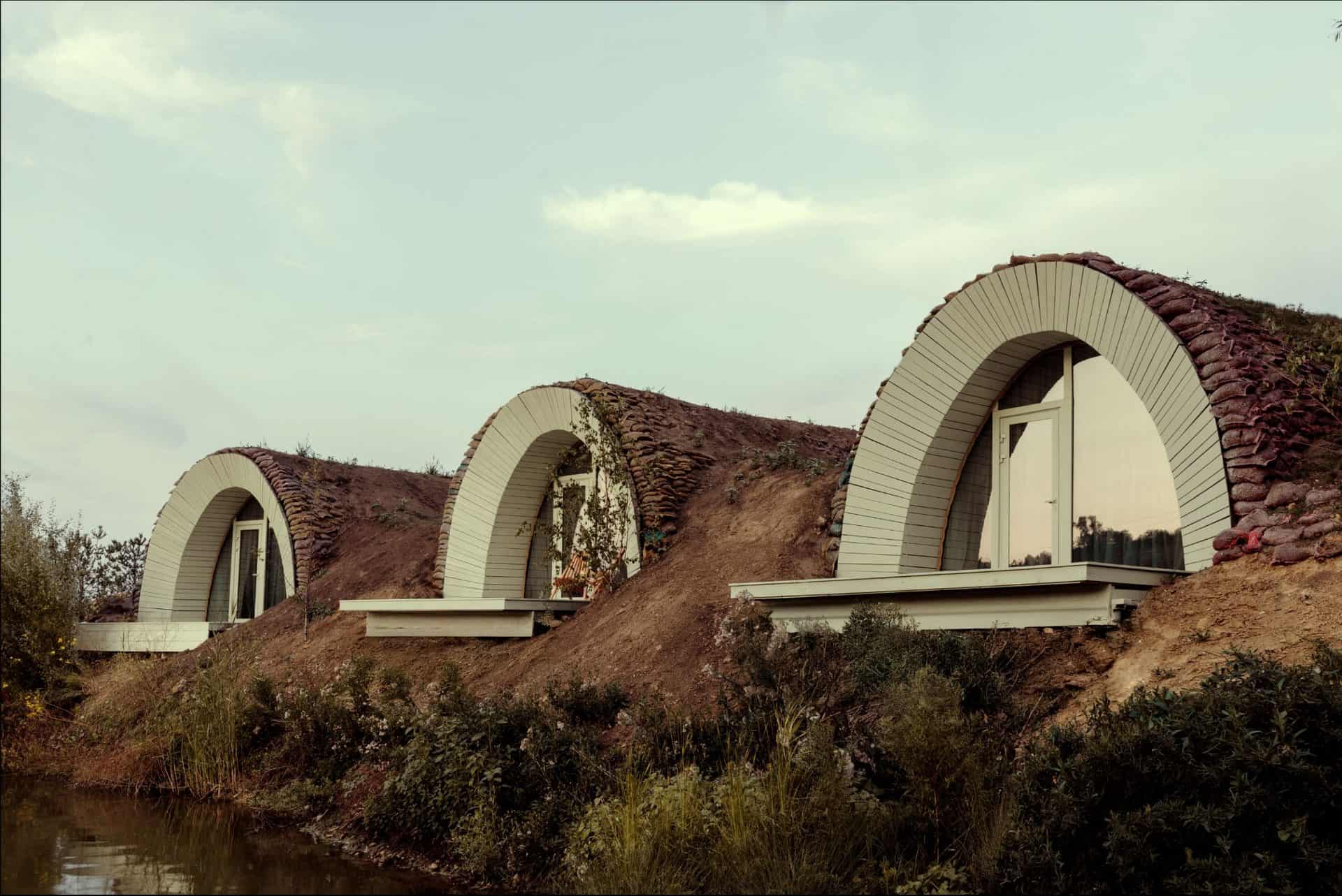 Eco-friendly house with arched roof design blending modern architecture and sustainable building techniques.