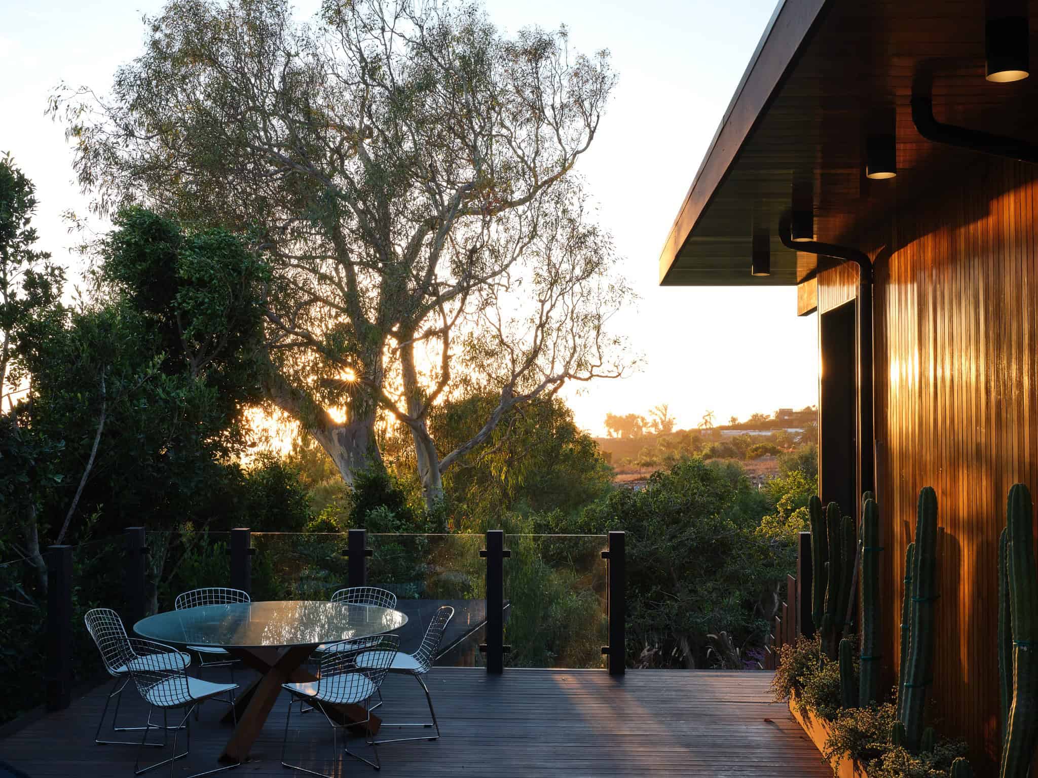 Malibu Glass Box House by Klopf Architecture – deck dining at sunset, Malibu, California