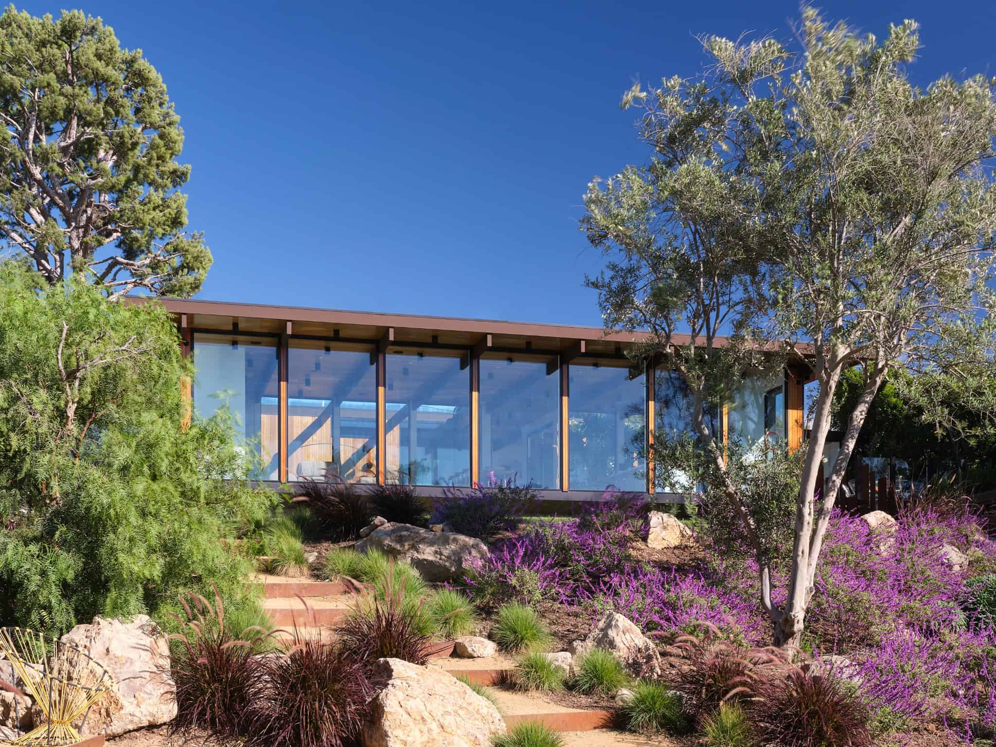 Malibu Glass Box House by Klopf Architecture – facade through landscape, Malibu, California