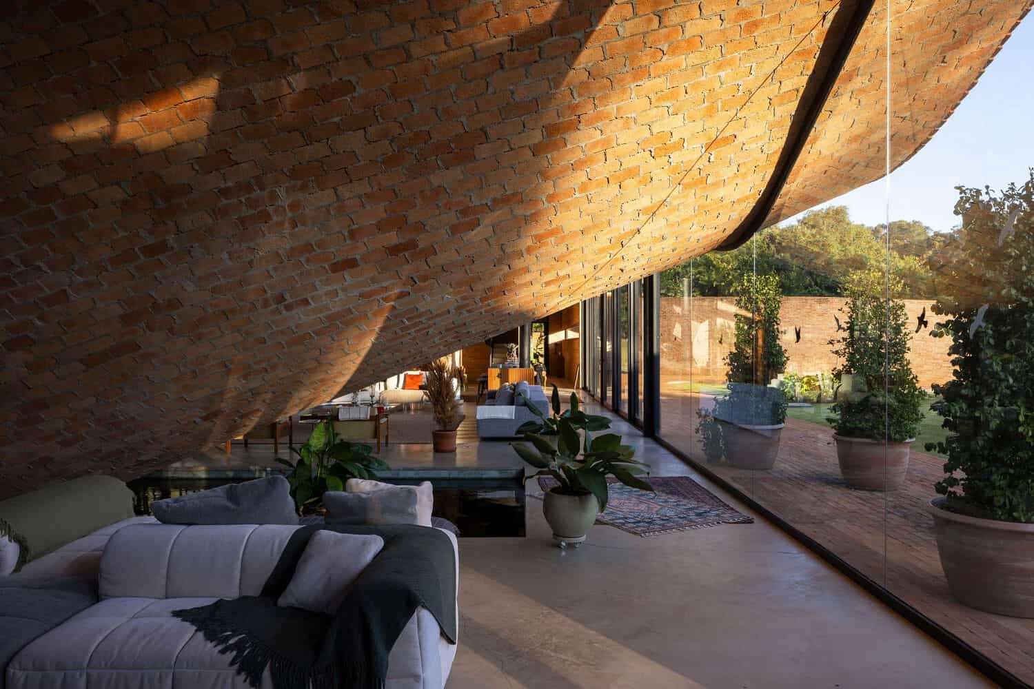 Passive House Interior Under Brick Vault by Mareines Arquitetura Passive House interior beneath sculptural brick vault, São Paulo, Brazil