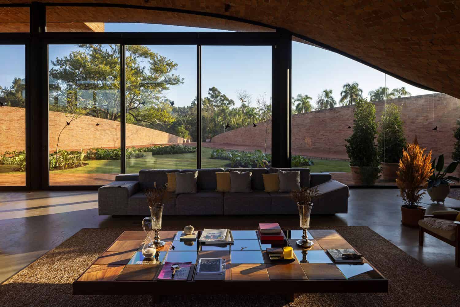 Passive House Living Room View by Mareines Arquitetura Passive House living room with panoramic glazing to garden, São Paulo, Brazil