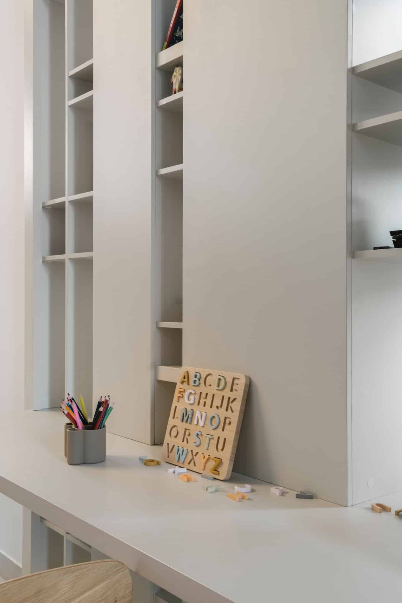 RIVER Kids Desk Alphabet Board by VSA.studio Minimalist white built-in open shelf cabinetry in modern home interior.