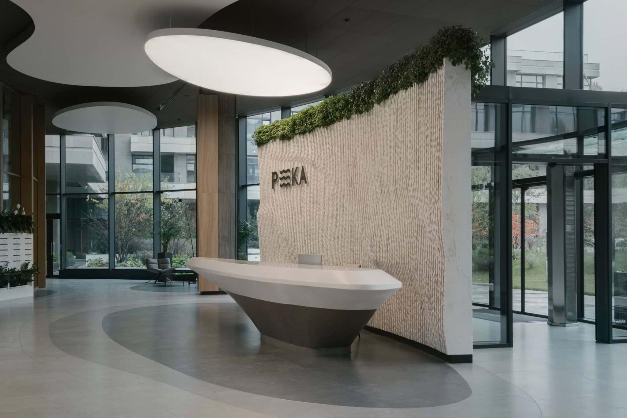 Modern office building lobby with minimalist design, natural lighting, and contemporary decor, showcasing innovative architecture and interior design elements.