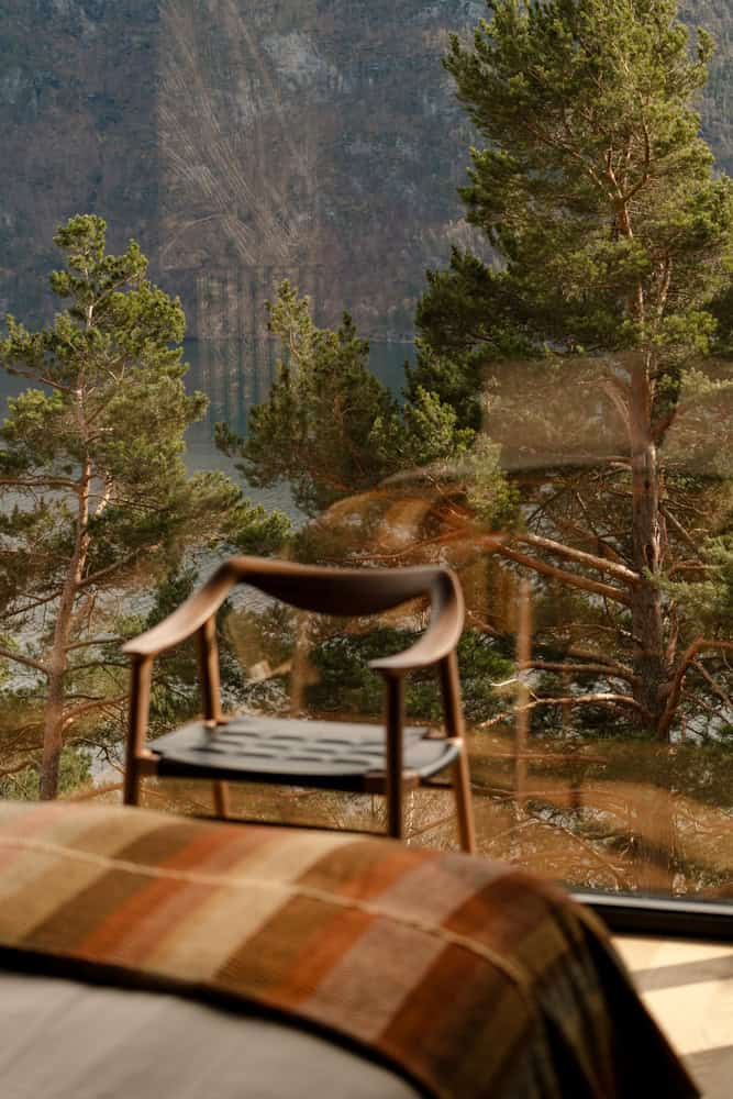 18-07 Holiday Home Bedroom Chair Reflection by OFFICE INAINN 18-07 Holiday Home by OFFICE INAINN, reflection of chair and forest in bedroom glass wall