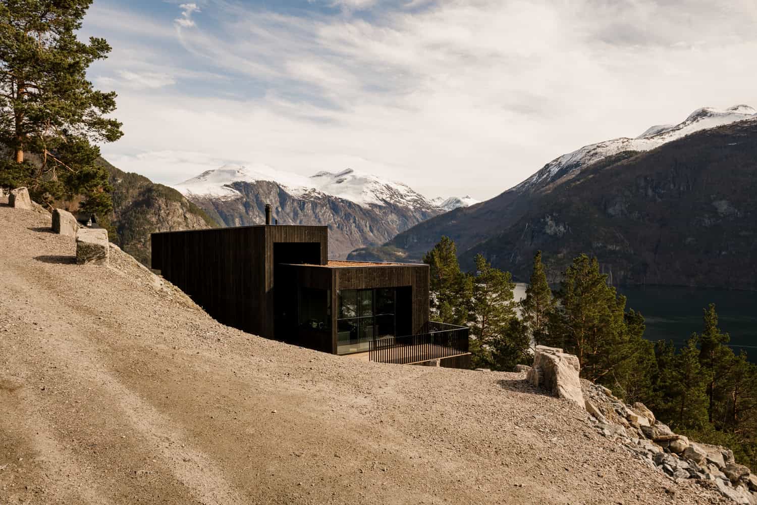 18-07 Holiday Home Entry from Road by OFFICE INAINN 18-07 Holiday Home by OFFICE INAINN, approach from mountain road above Norwegian fjord