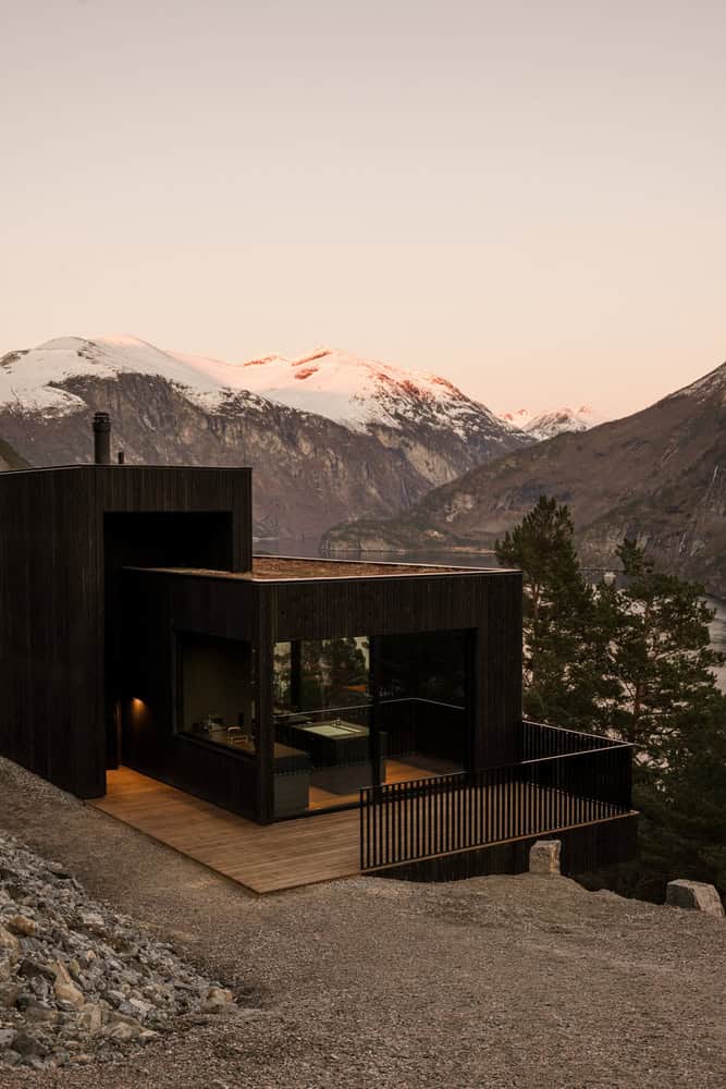 18-07 Holiday Home Evening Glow Facade by OFFICE INAINN 18-07 Holiday Home by OFFICE INAINN, facade glowing in evening light over Norwegian fjord