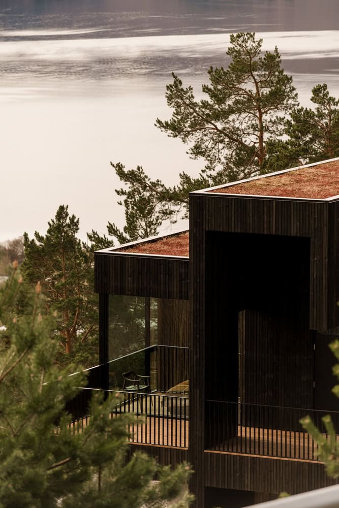 18-07 Holiday Home Forest Balcony View by OFFICE INAINN 18-07 Holiday Home by OFFICE INAINN, balcony overlooking forest and fjord in coastal Norway