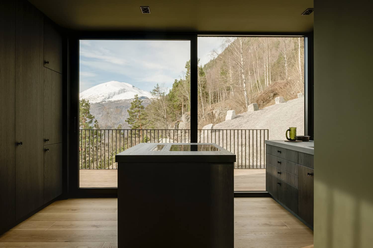 18-07 Holiday Home Kitchen Mountain View by OFFICE INAINN 18-07 Holiday Home by OFFICE INAINN, kitchen island with mountain view framed by glass wall